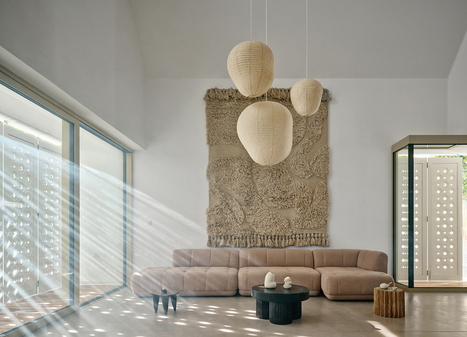 A living room with a large wall hanging over the couch.