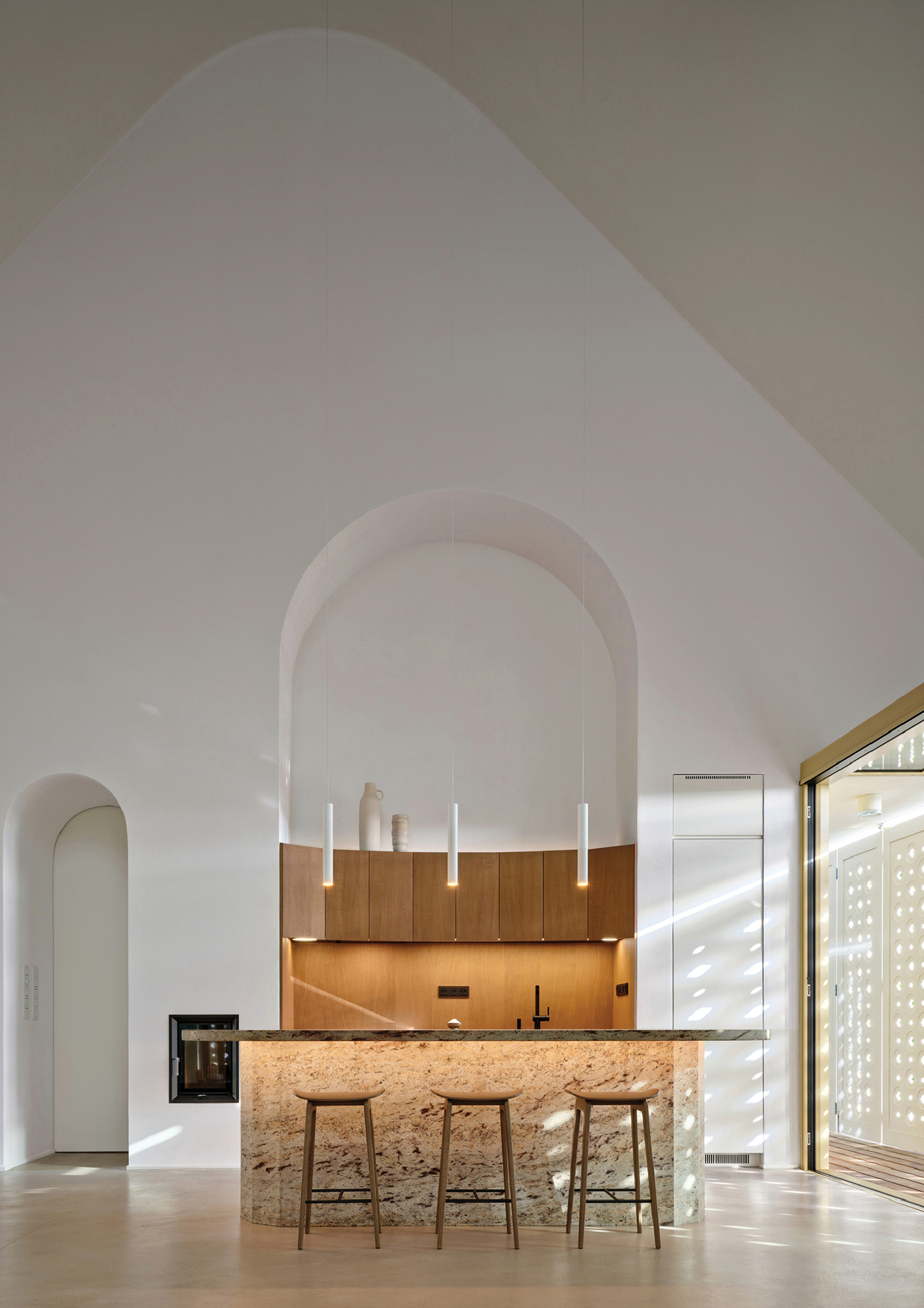 A kitchen with a bar and a table.