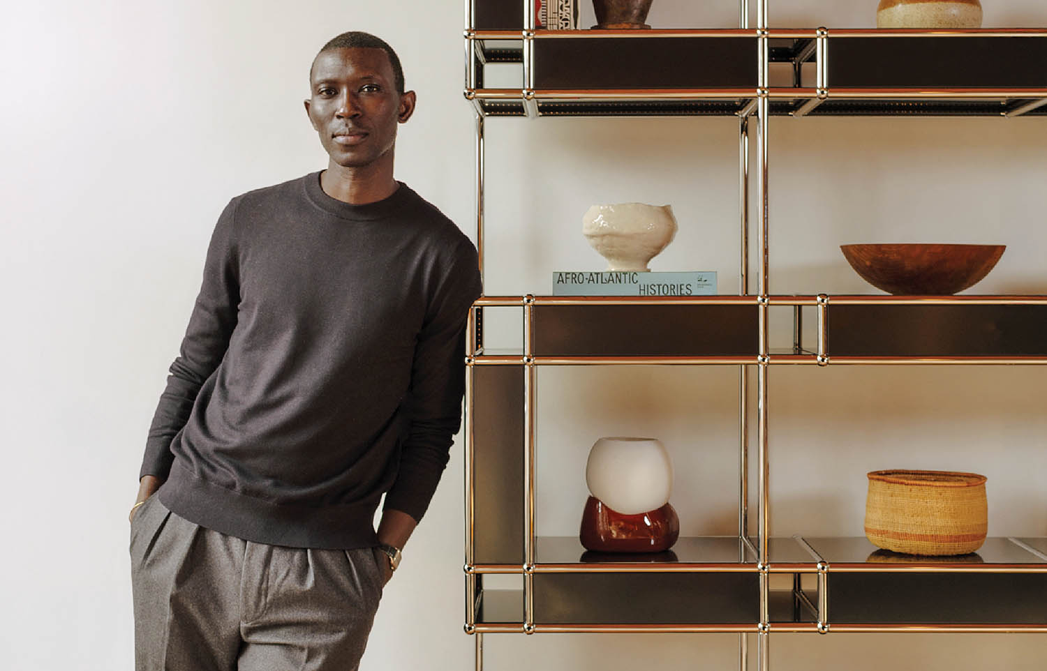 A man standing in front of a shelf