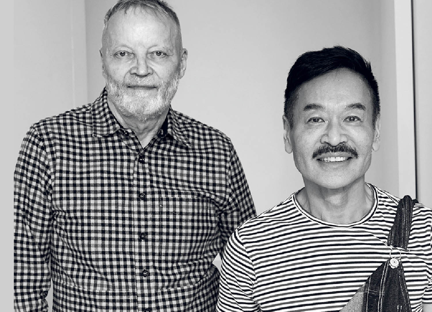 Two men standing next to each other man.