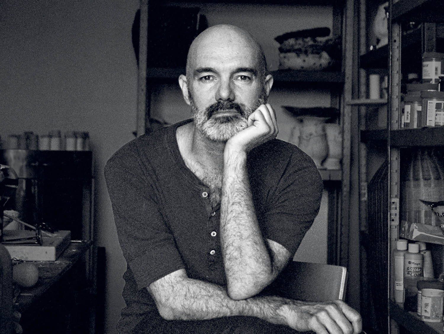 A man with a beard sitting in a chair.