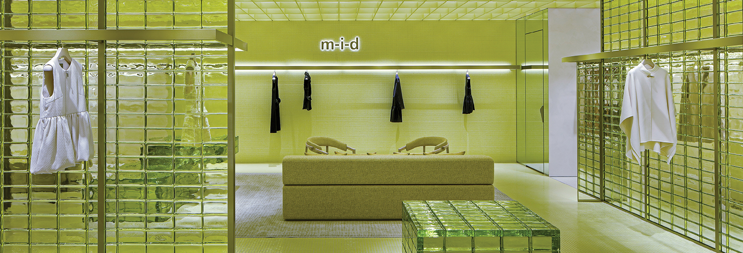 A room with a couch and a mirror.