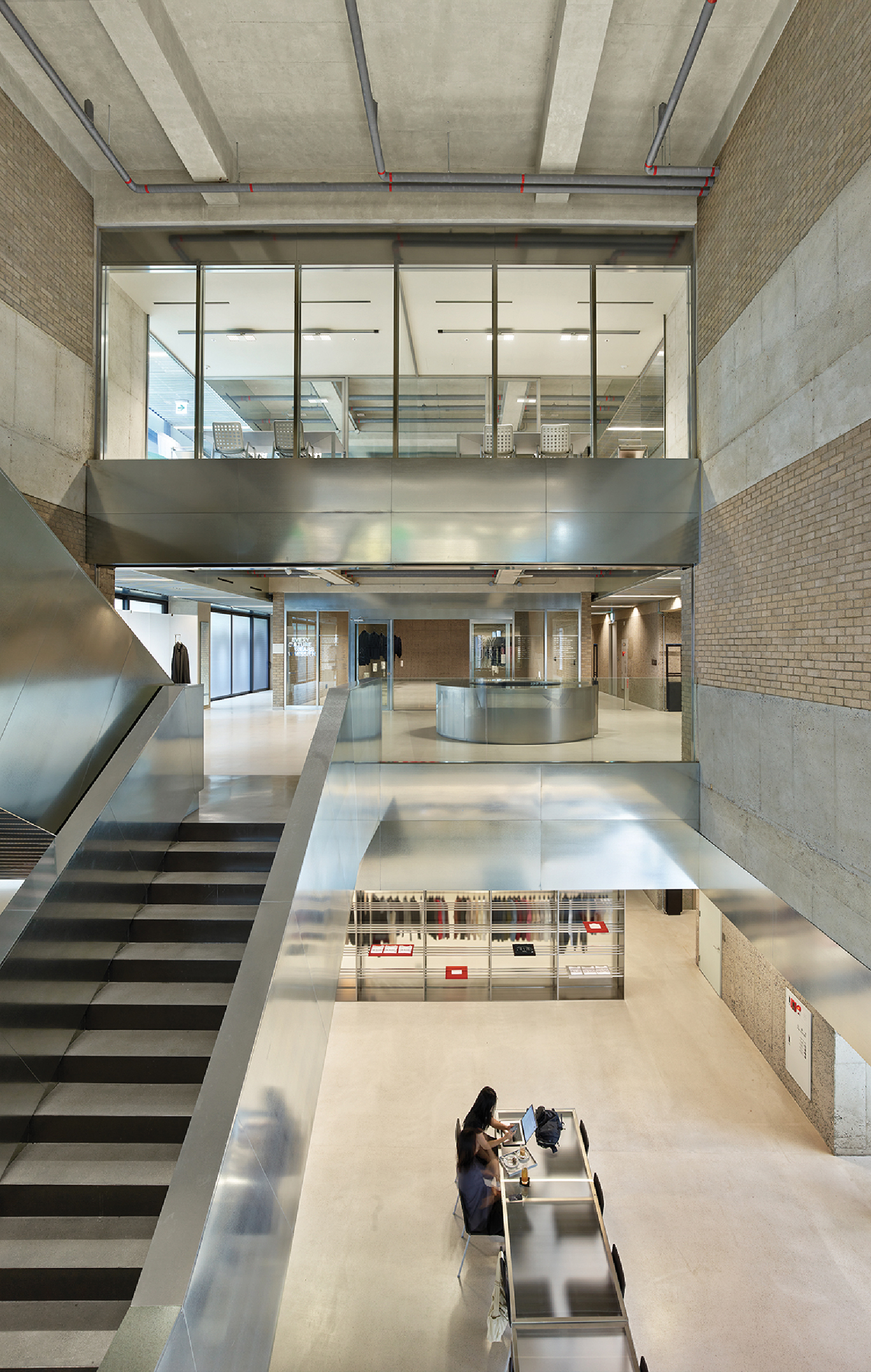 A person sitting on a bench in a building.