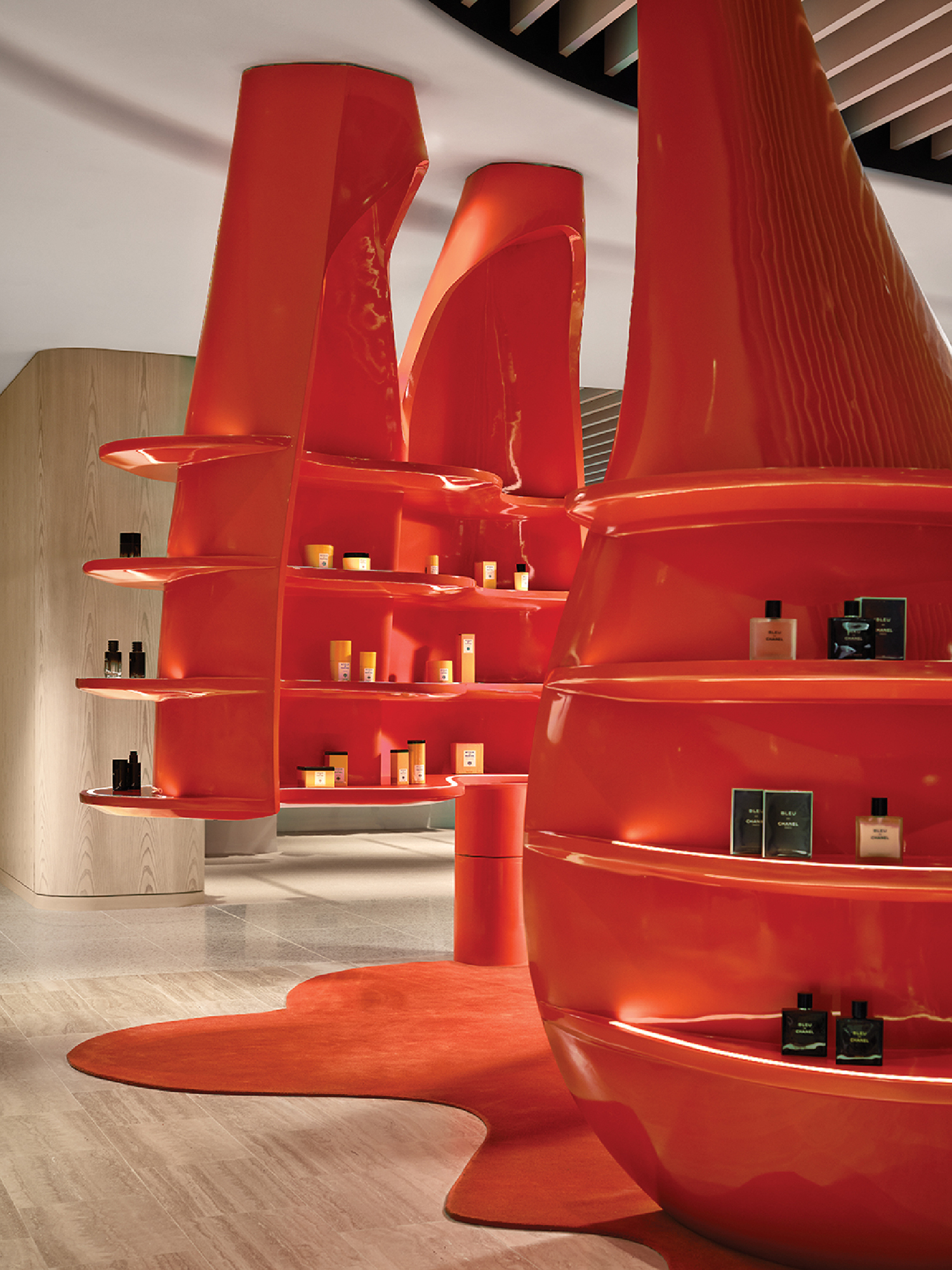 A room with a large orange sculpture on the floor.