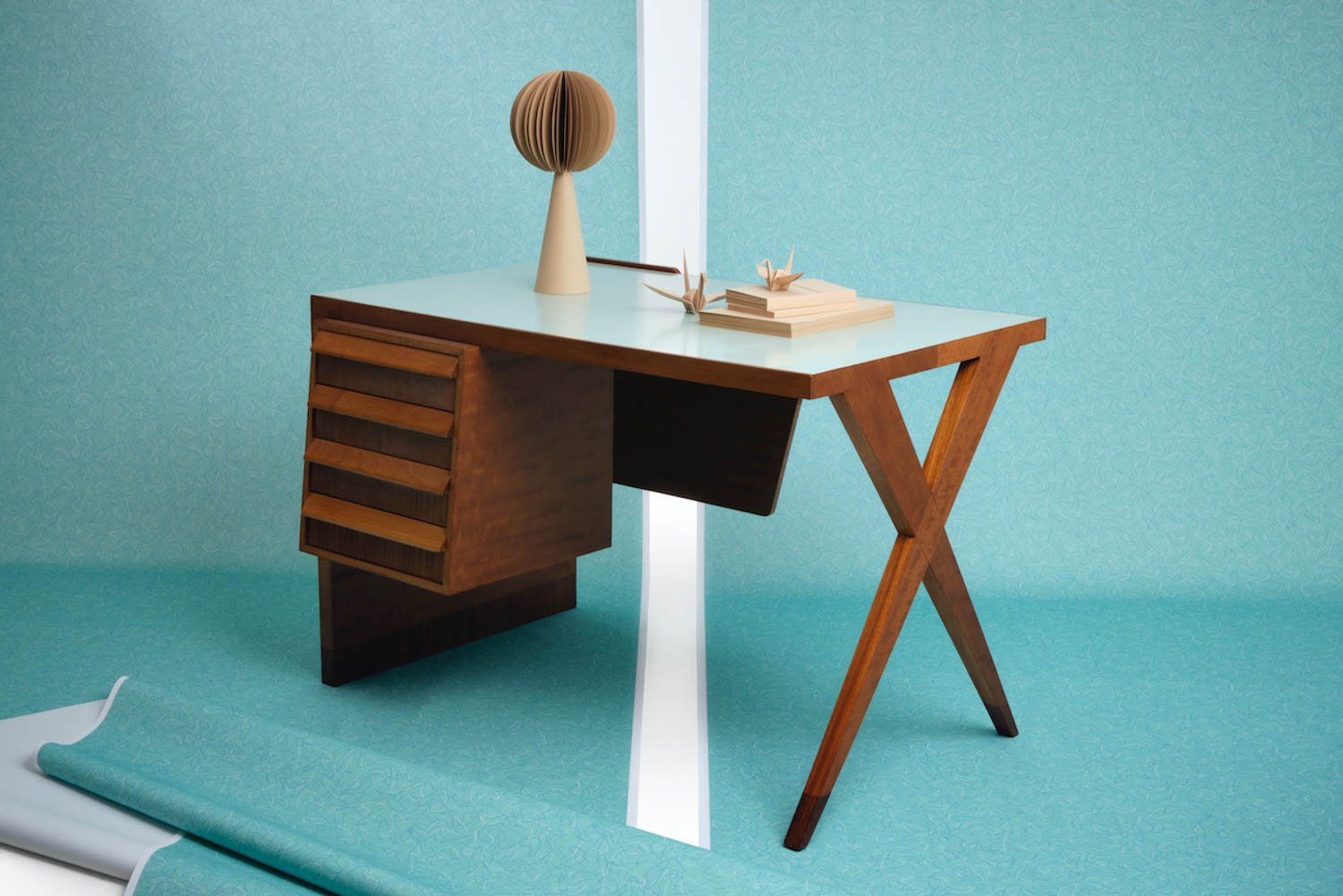 brown desk against a teal background