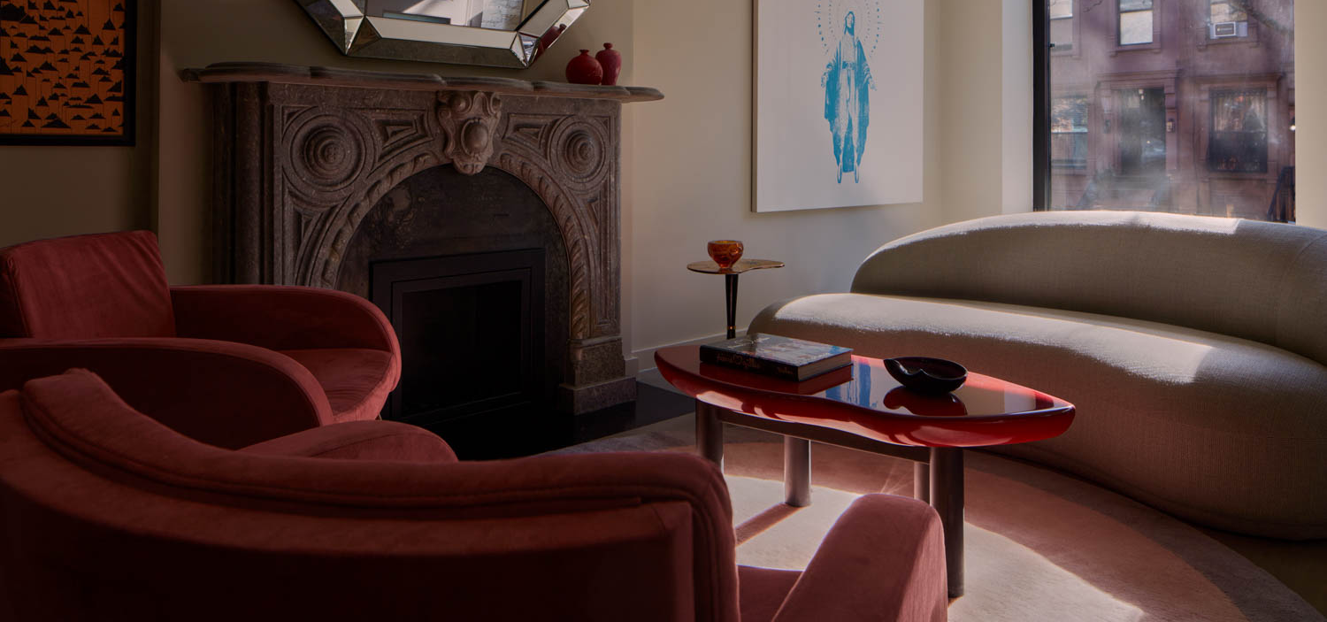 living room with red chair and fireplace