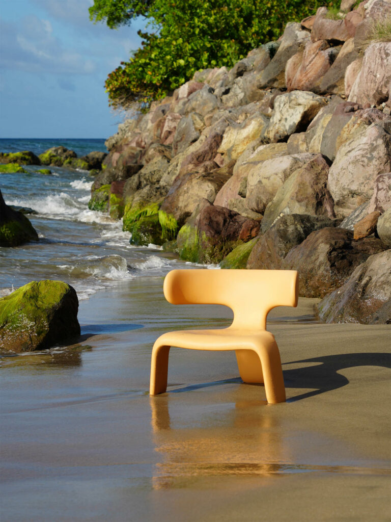 an orange chair on a beach