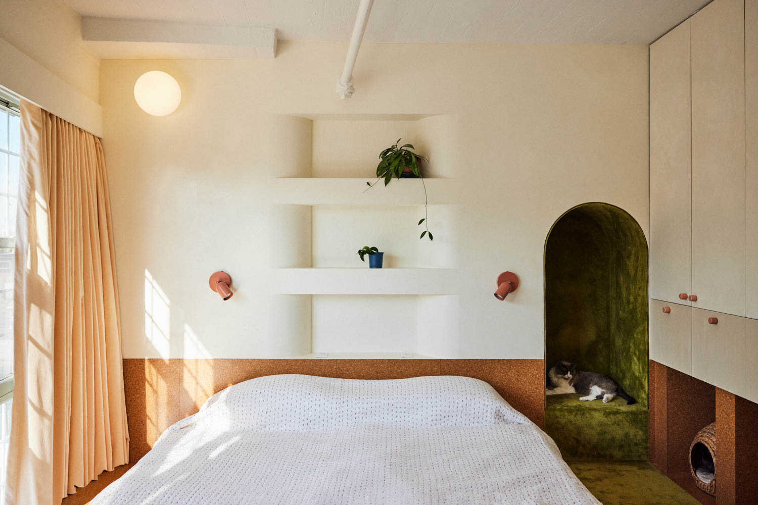bedroom with white walls and arched entryway
