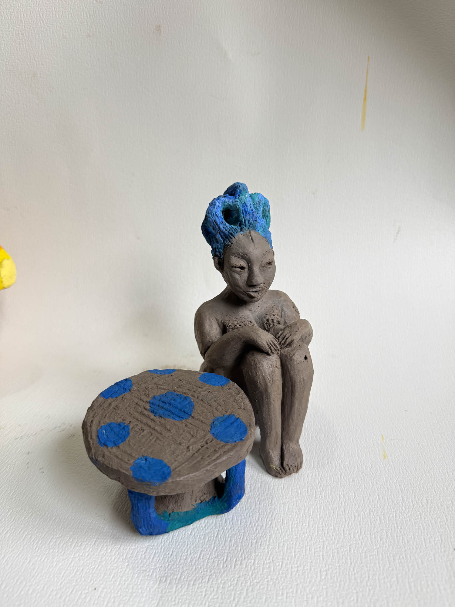 one woman sitting by a table