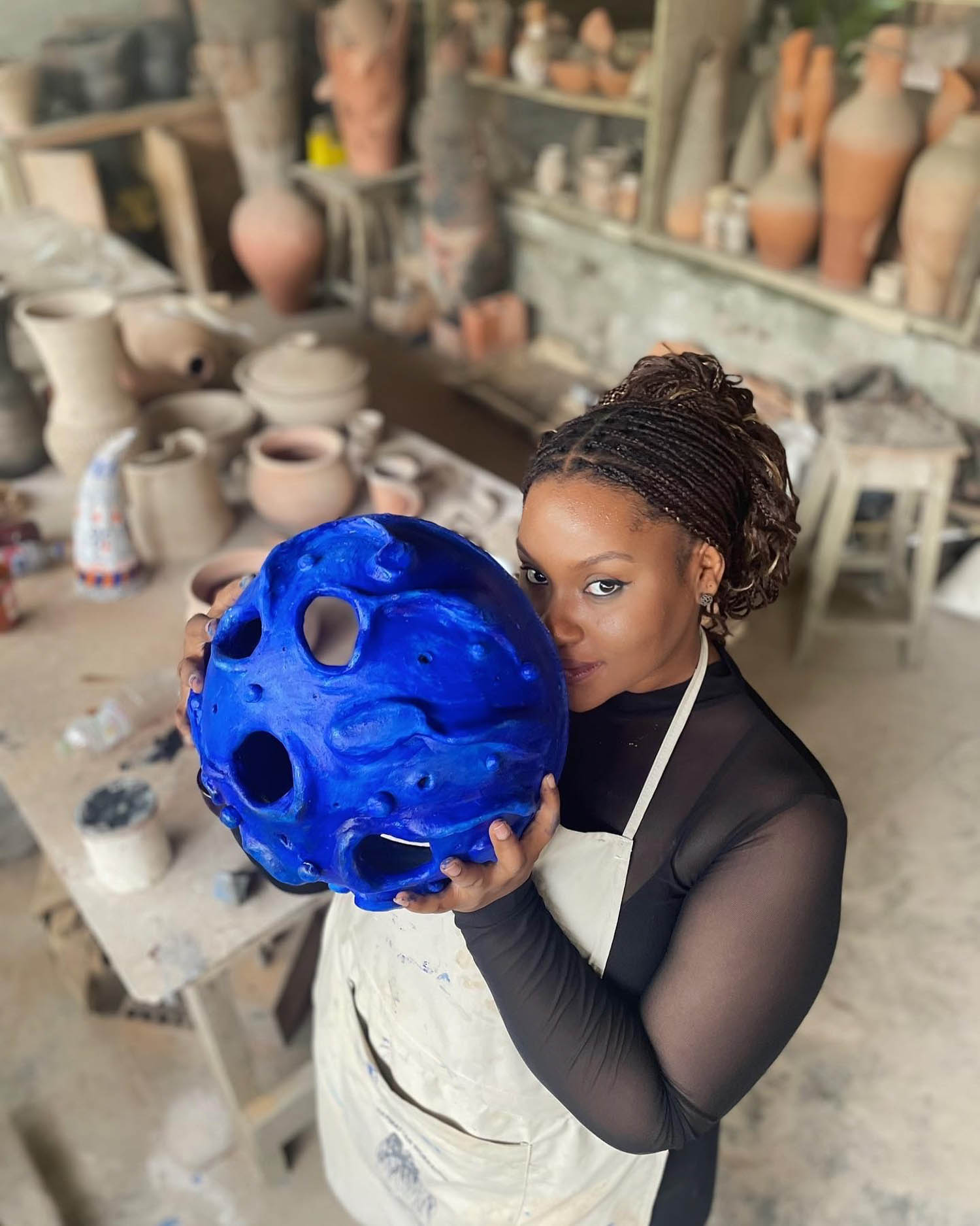 Fiyin Koko holding a blue piece of work