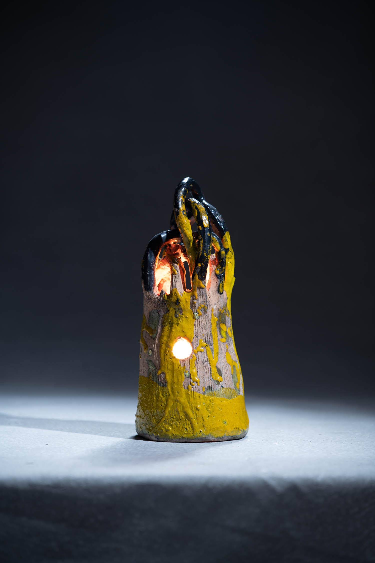 a yellow lighthouse sculpture
