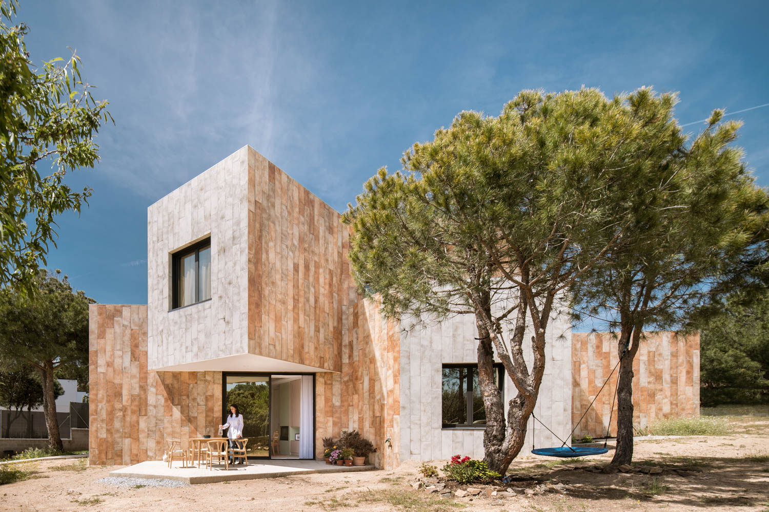 exterior of home with rock facade and trees