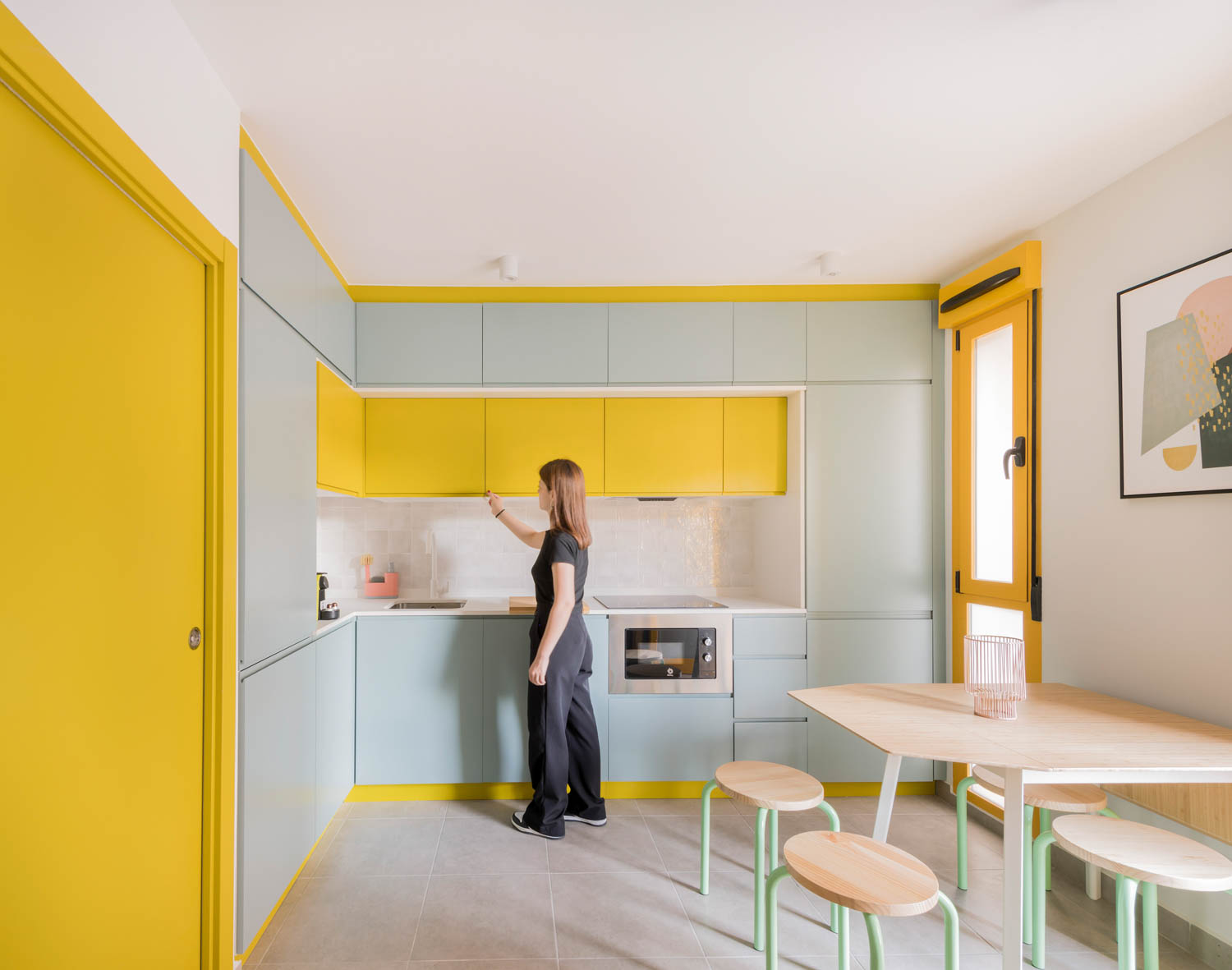 kitchen with pastel green cabinets and yellow doors