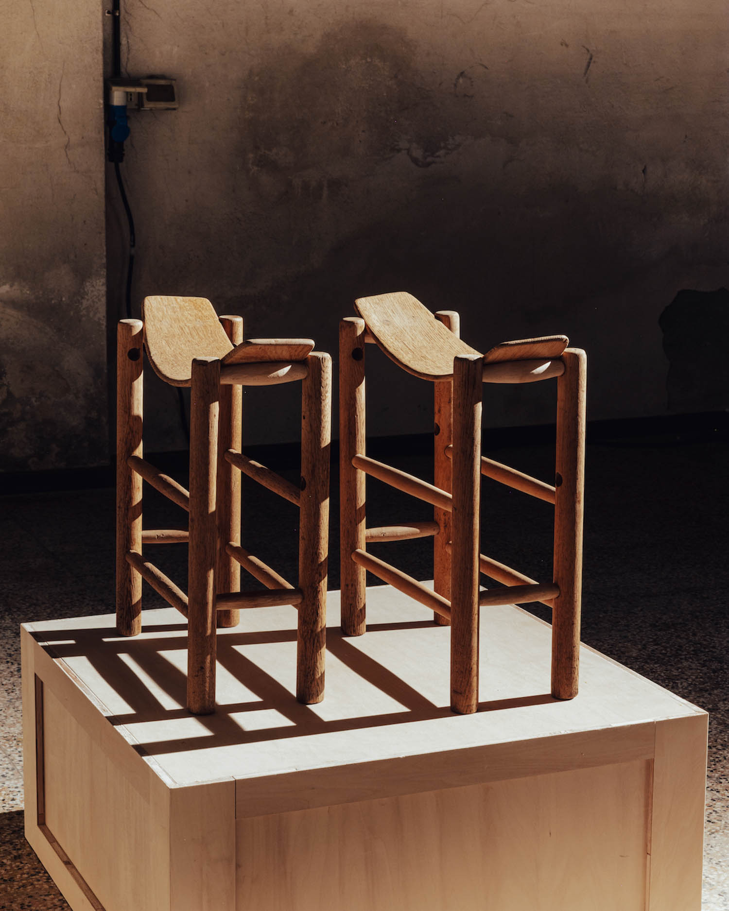 two skinny stools with curved seat