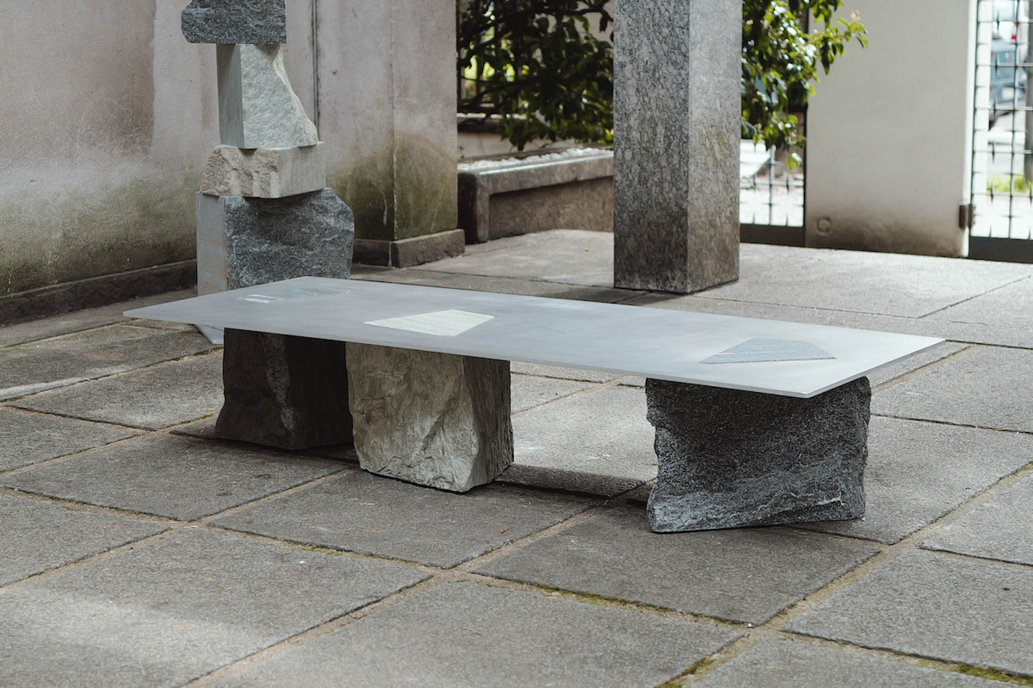 large stone bench with three stone bases