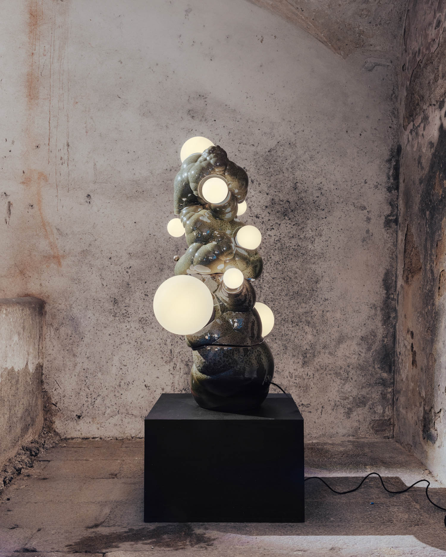 dark sculpture with lit orbs and amorphous shape