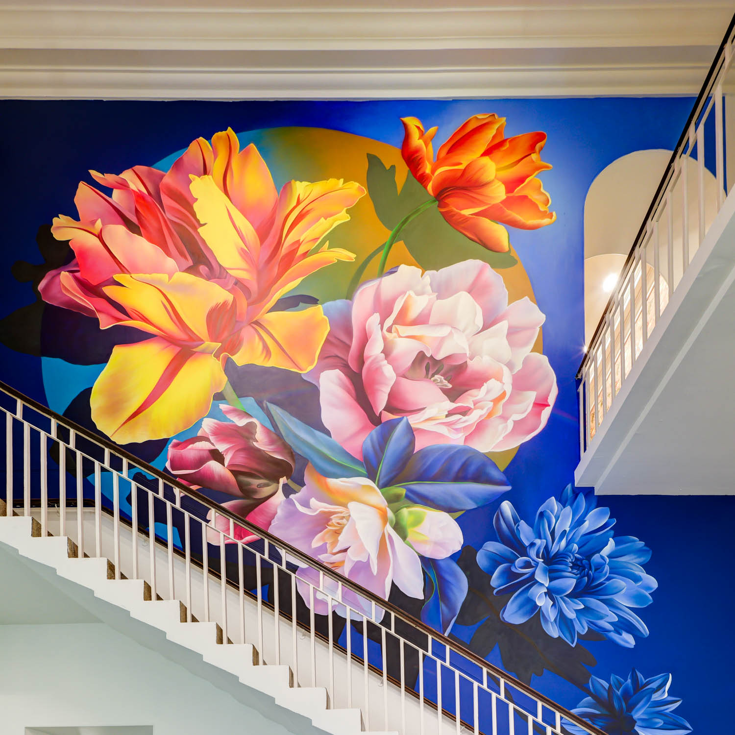 large floral mural by the stairs