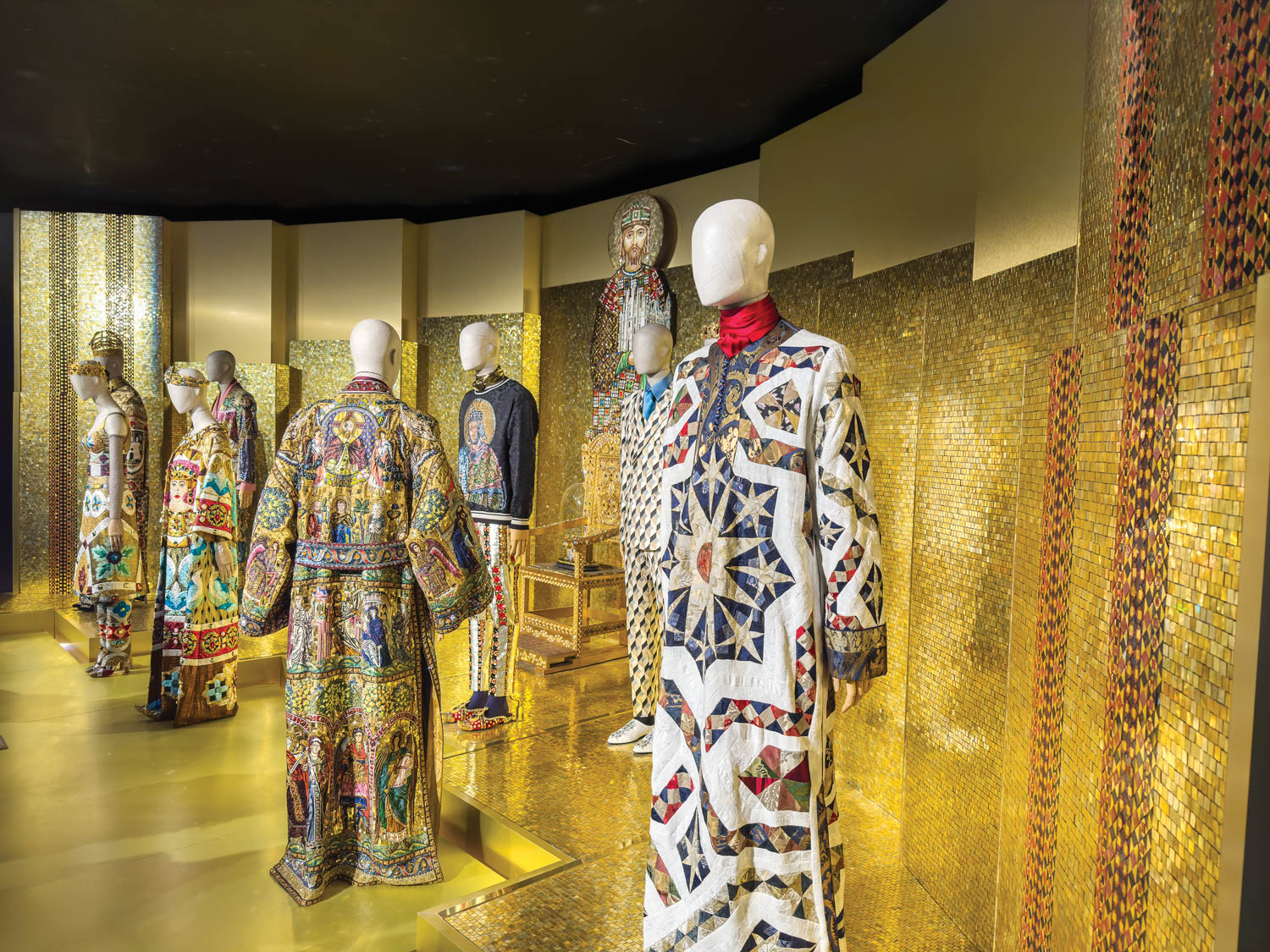 multiple intricate outfits in a gold room