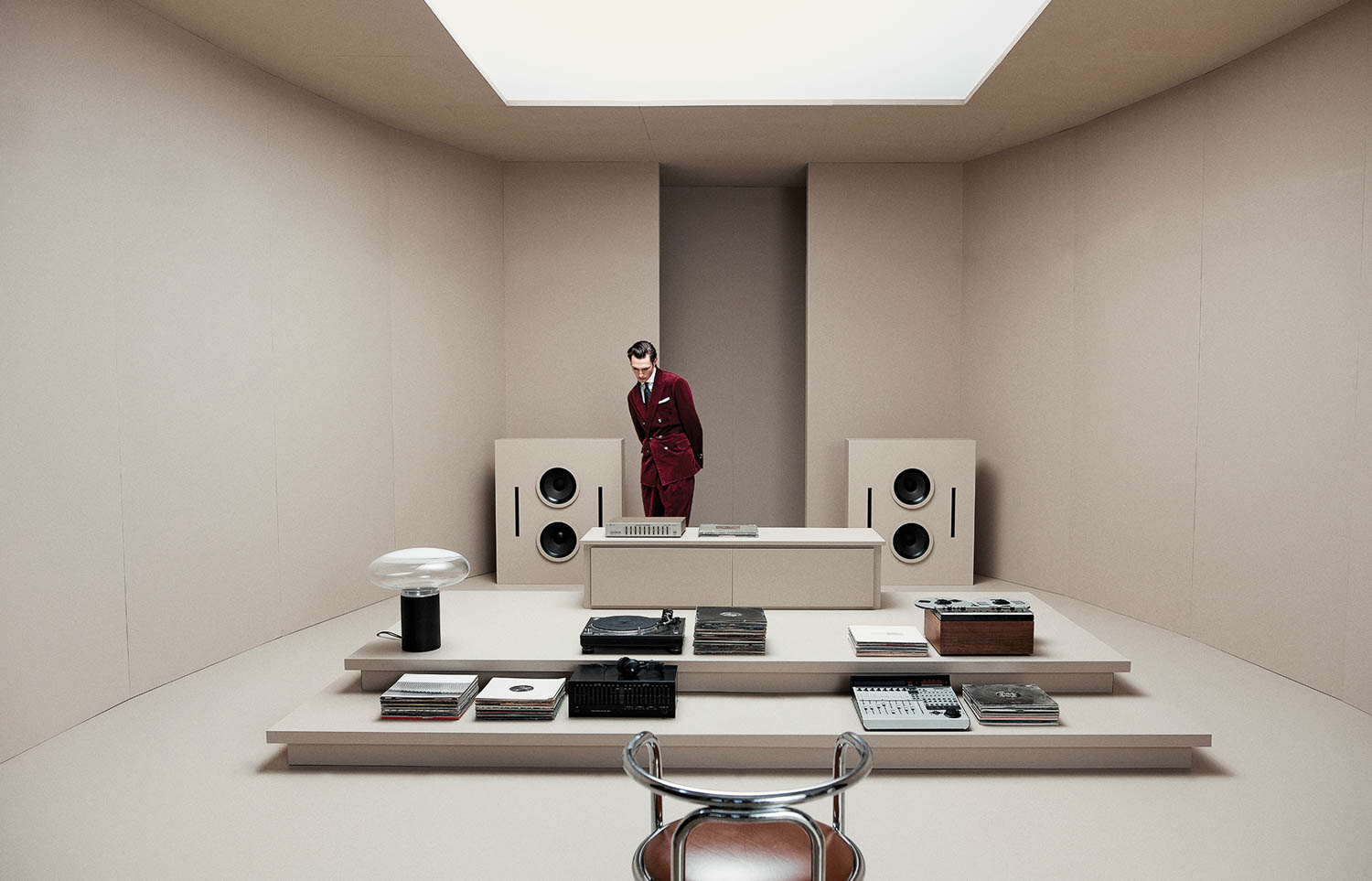 man walking around a set resembling a vintage radio station