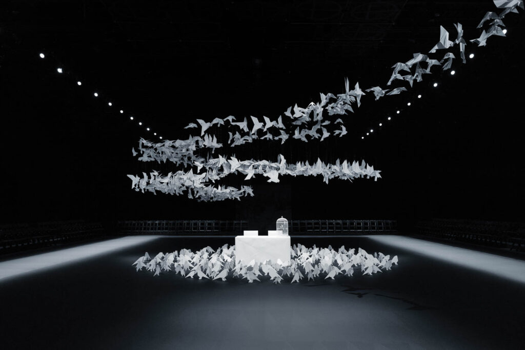 room with multiple birds flying around