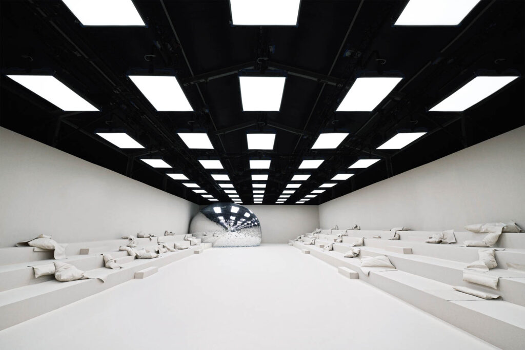 room with multiple bleachers and bright lights above