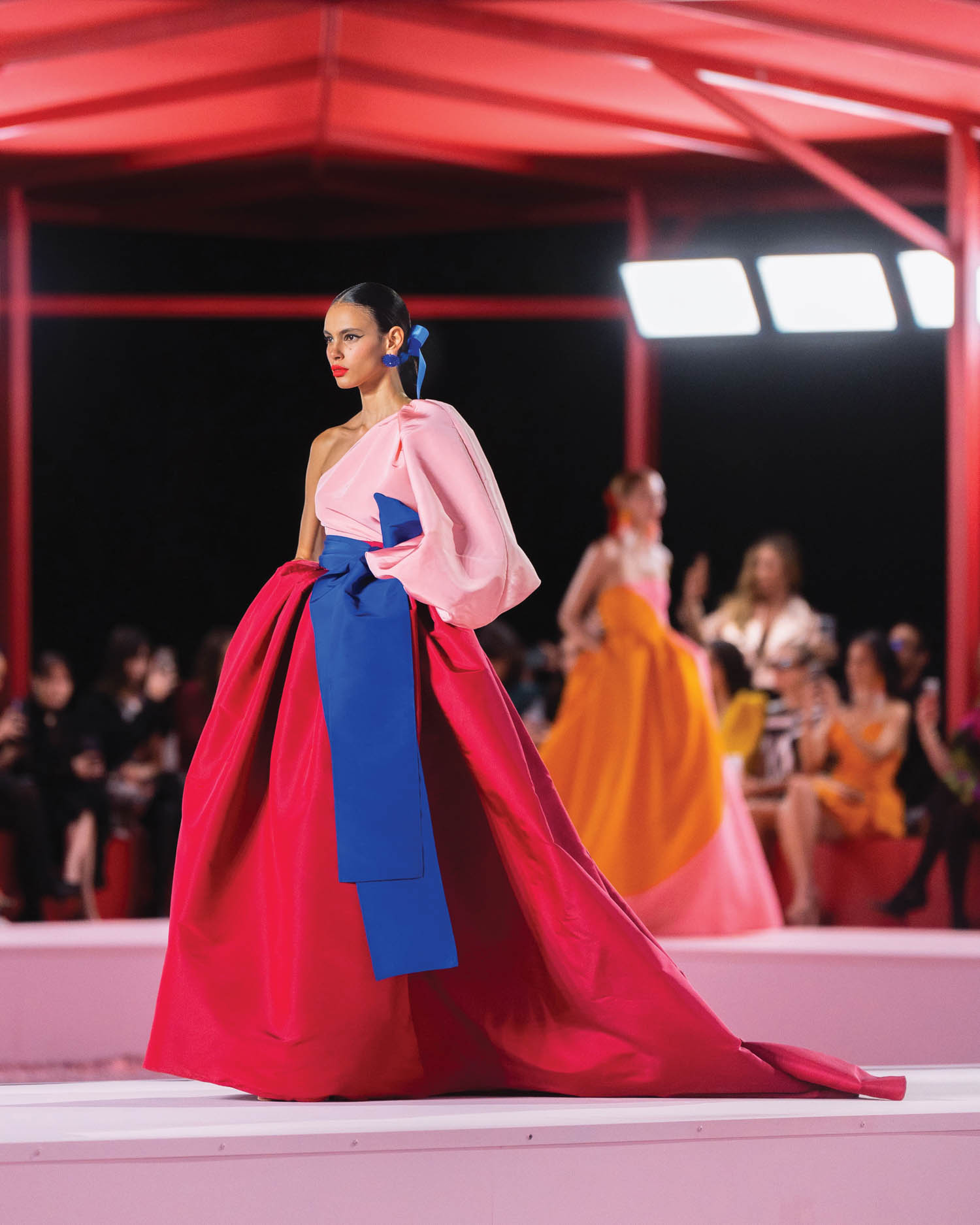 woman walking down catwalk with bright colorful clothing