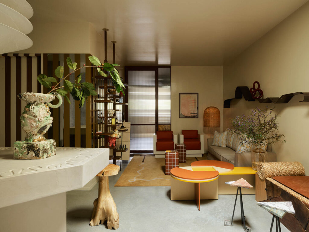 reception area with white reception table, orange table and couches