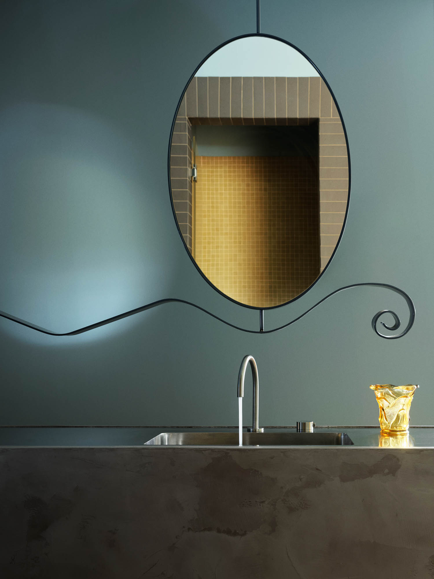 vanity with oval mirror and granite sink