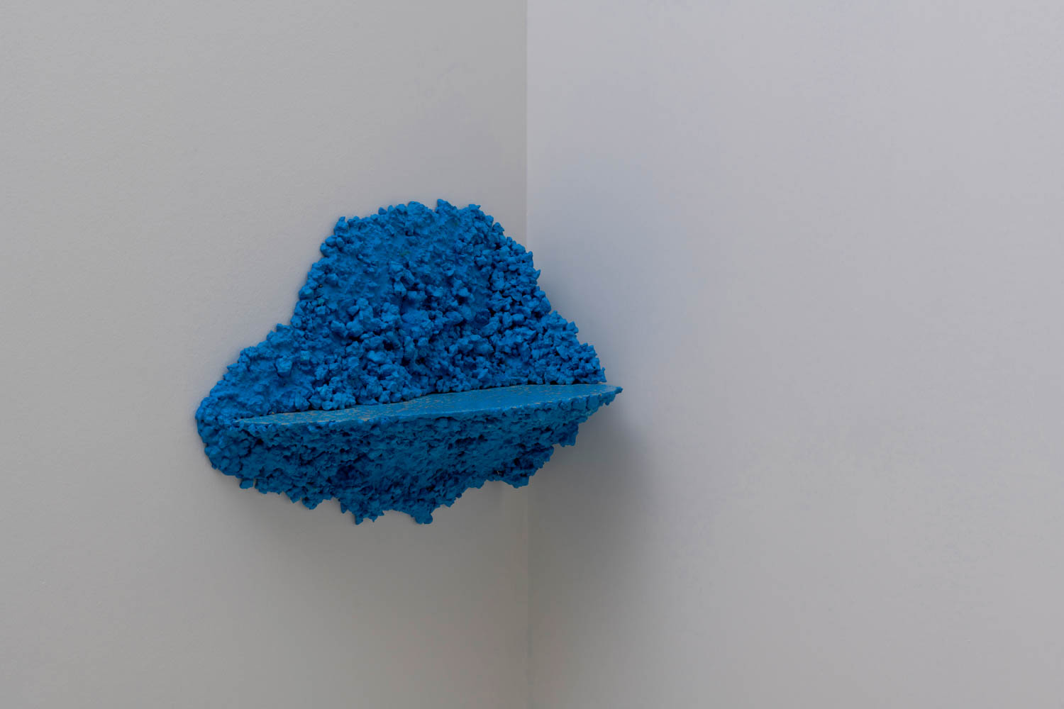 blue shelf hanging on the corner