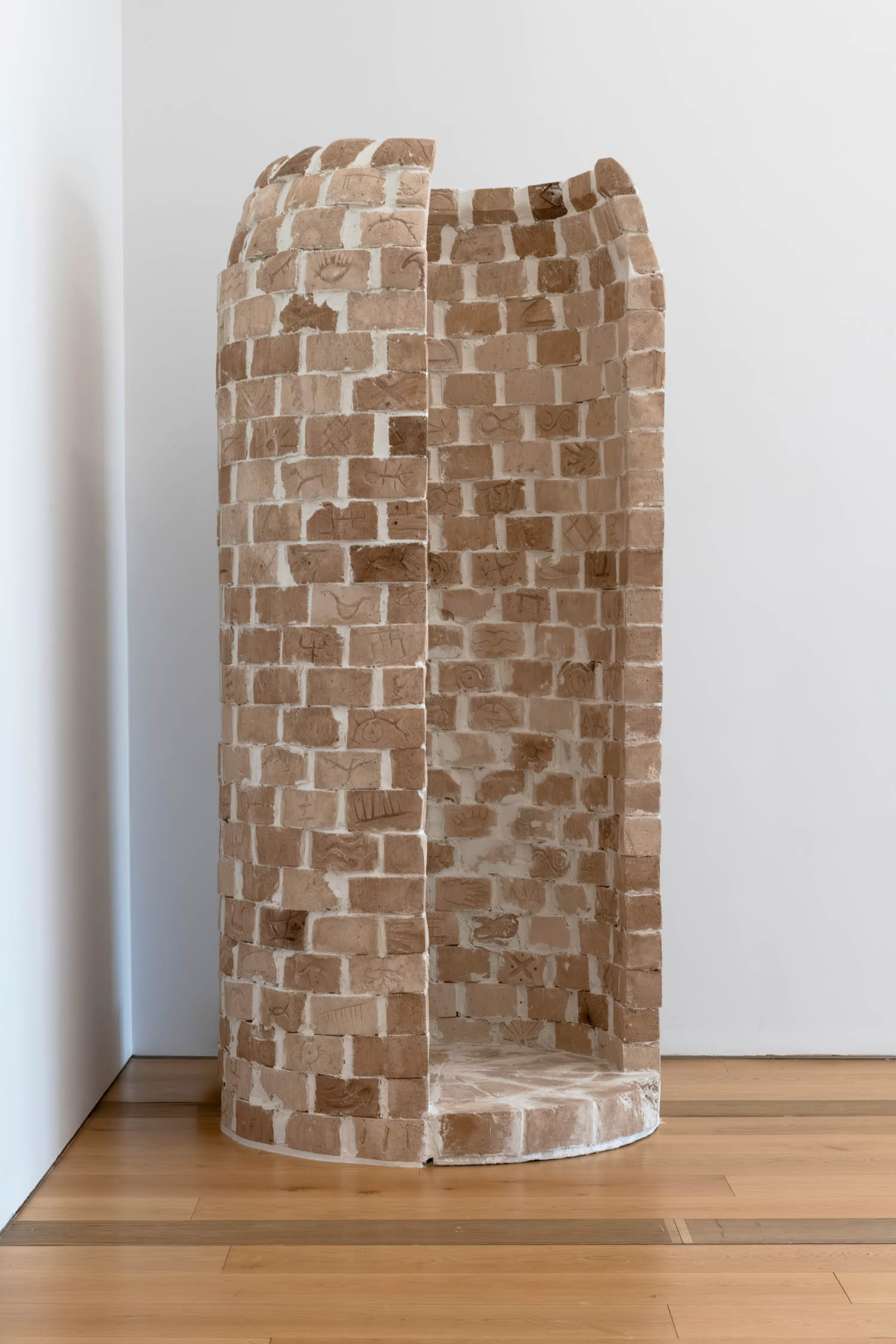 a brick wall/column with intricate symbols
