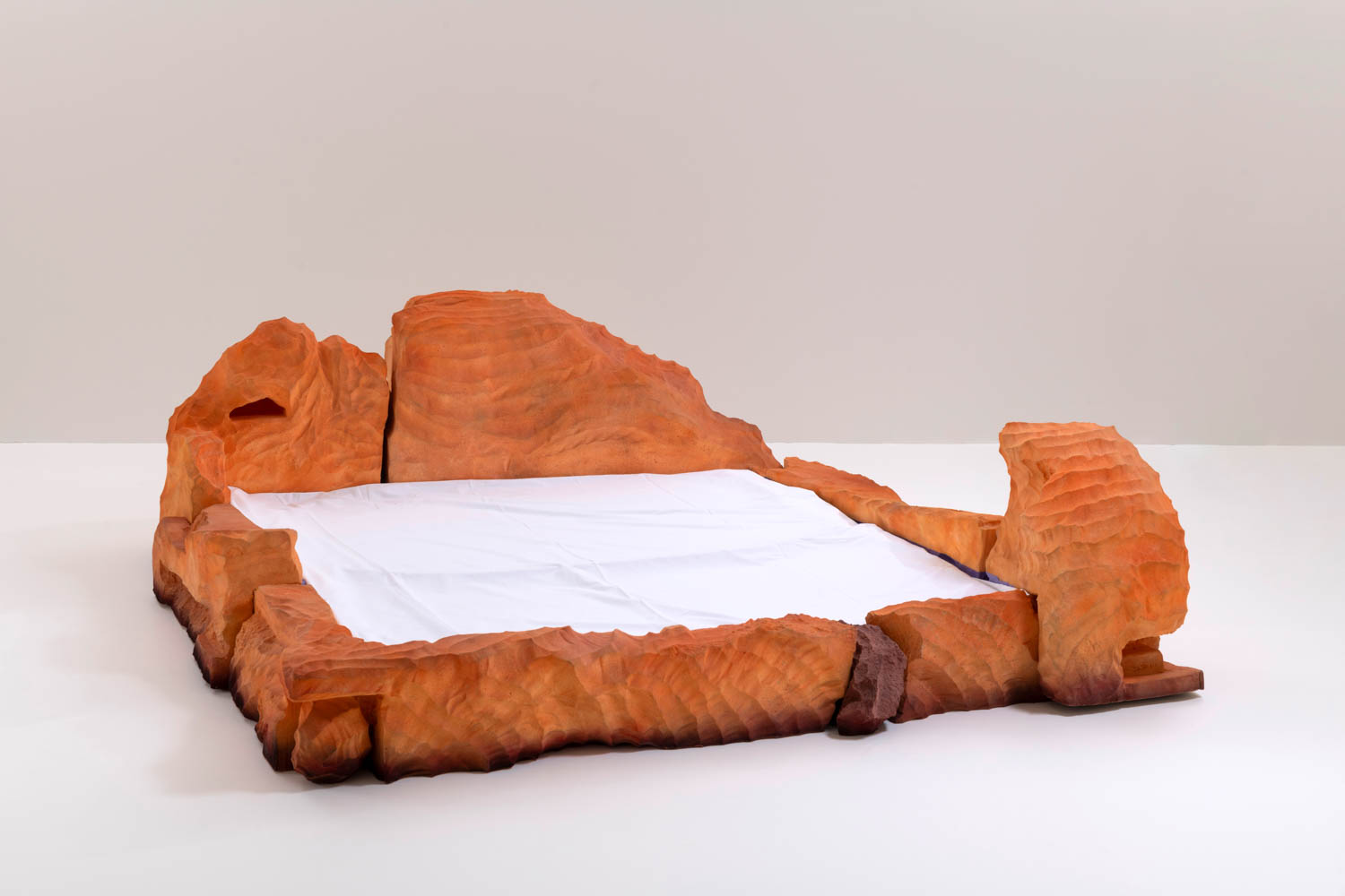 dark orange bed made of orange rock