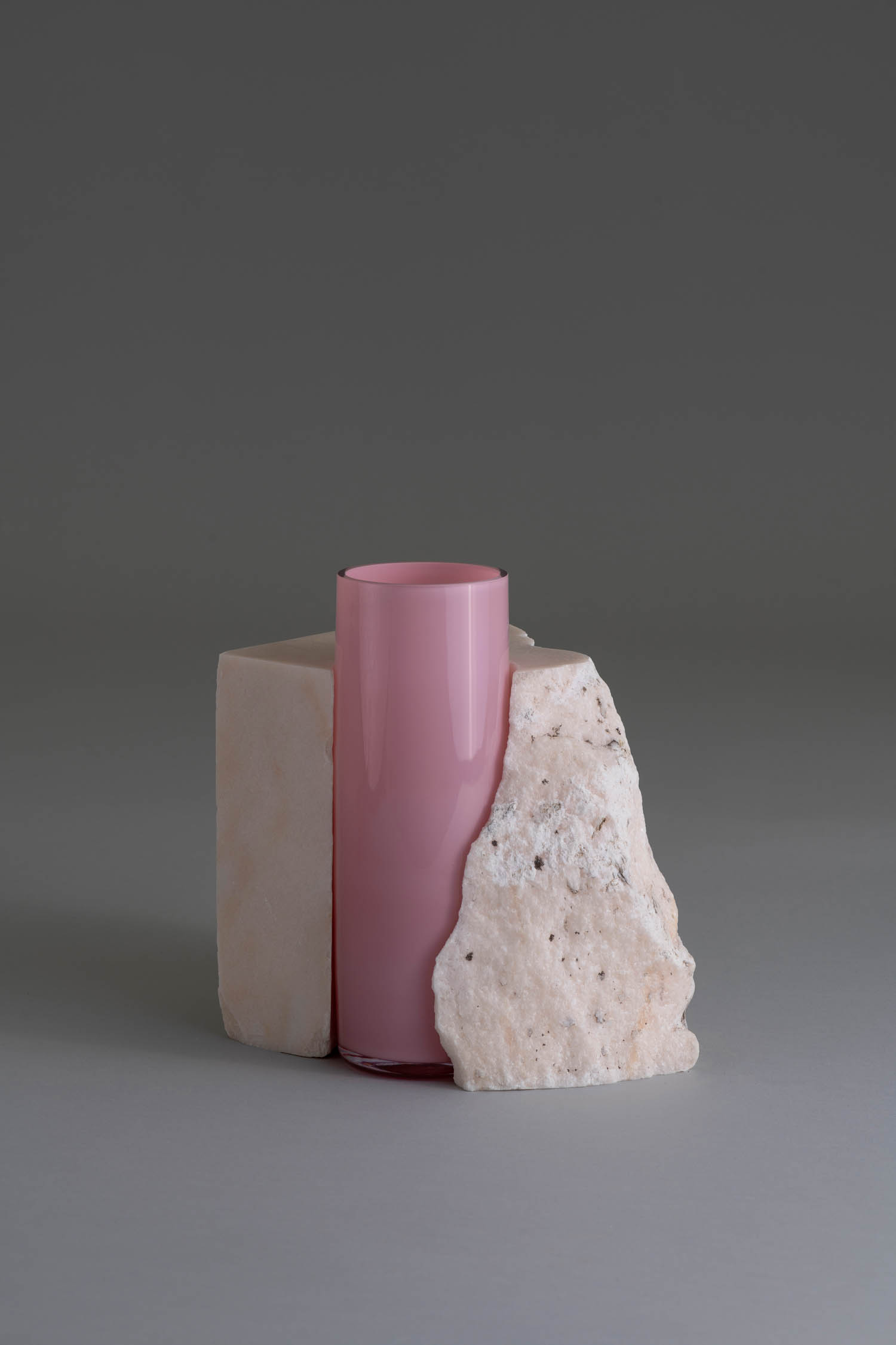 pink vase embedded in rock holder