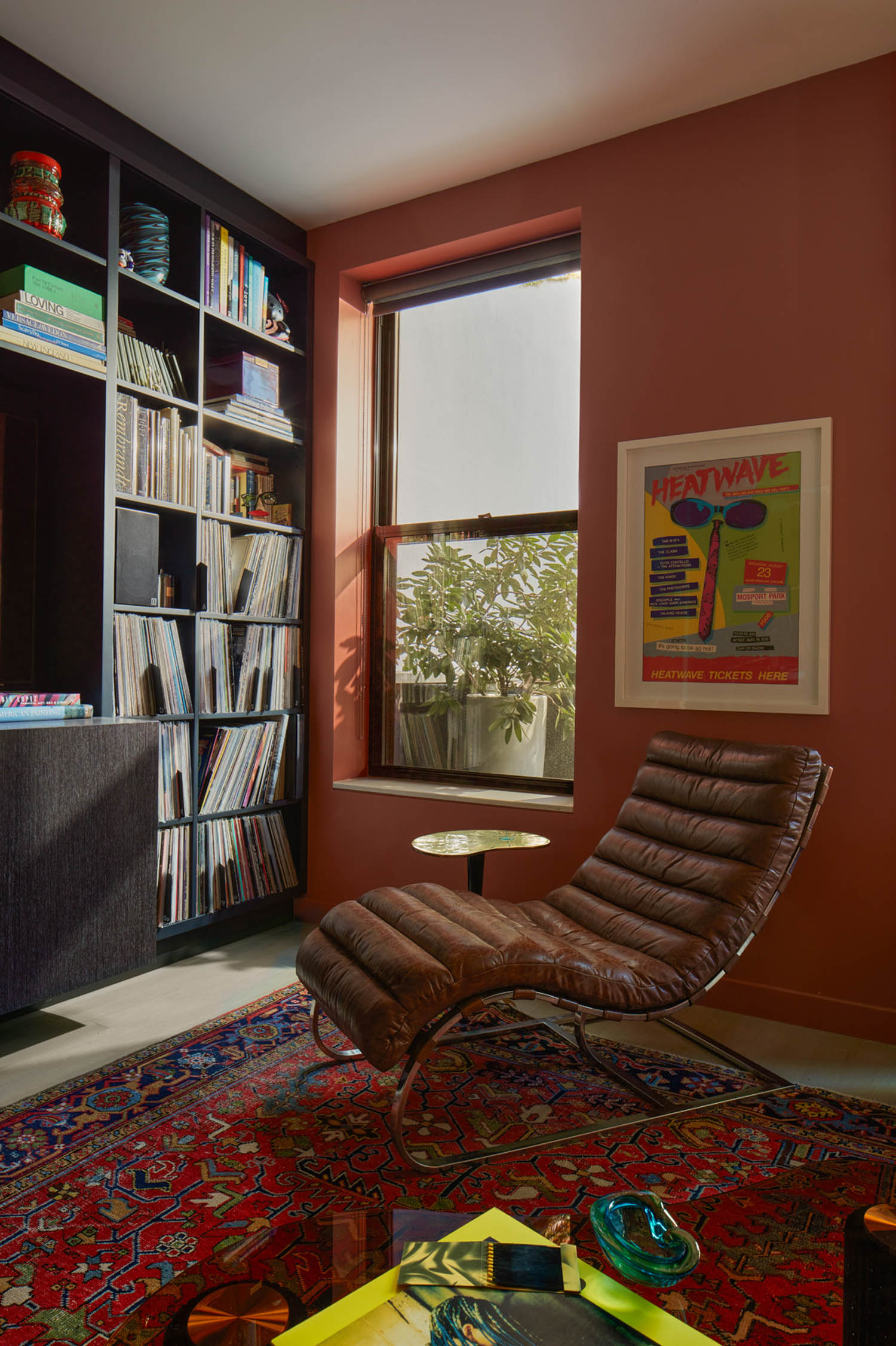 corner nook with terracotta walls and brown chair