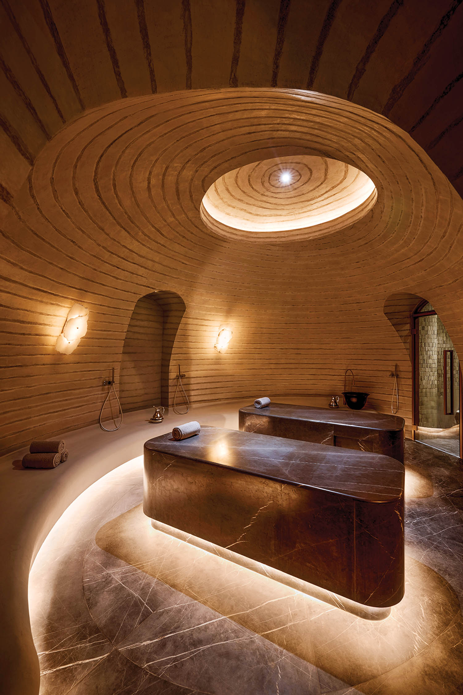 hammam with carved natural stone benches and bespoke plasterwork