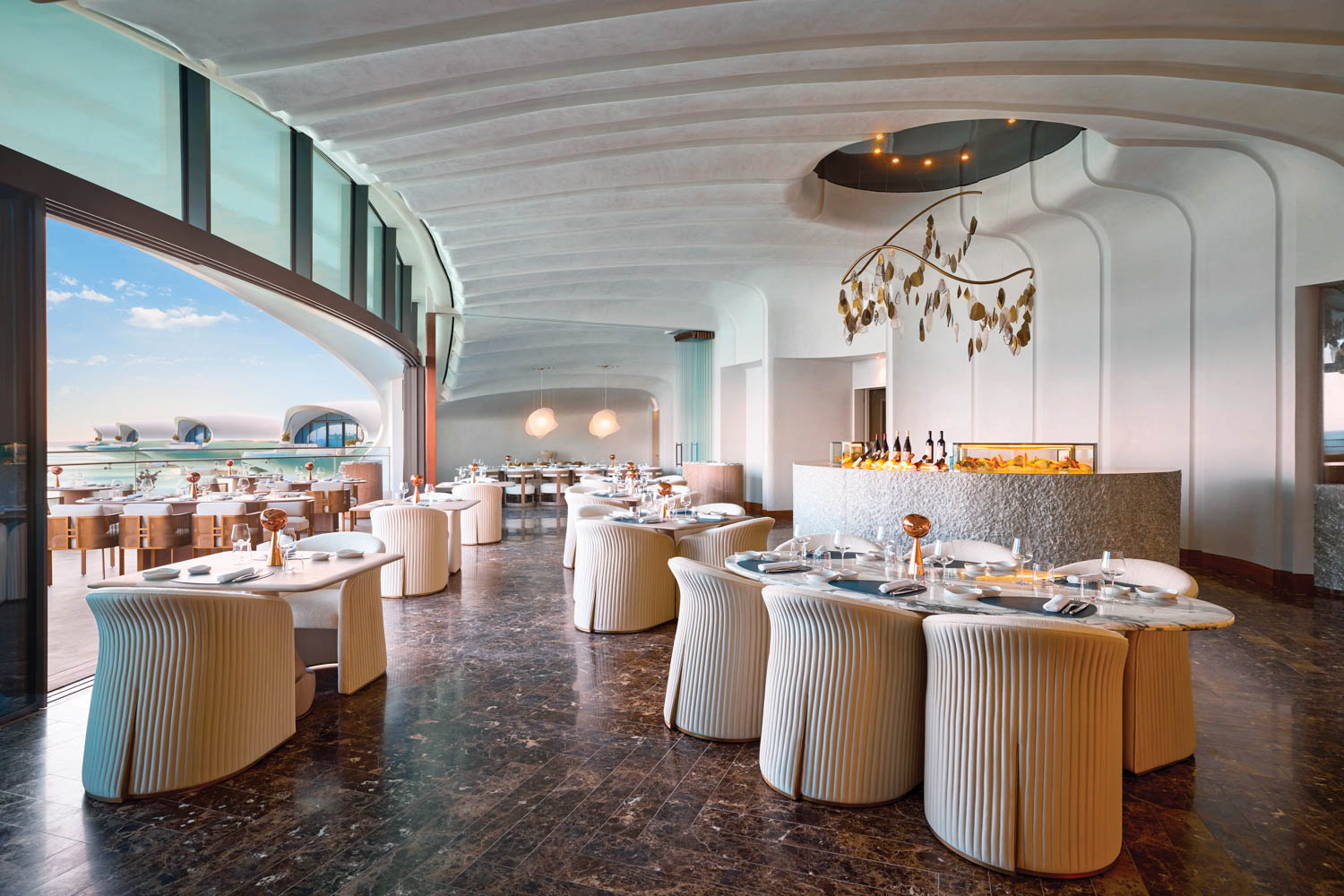 dining area with scalloped seating overlooking ocean