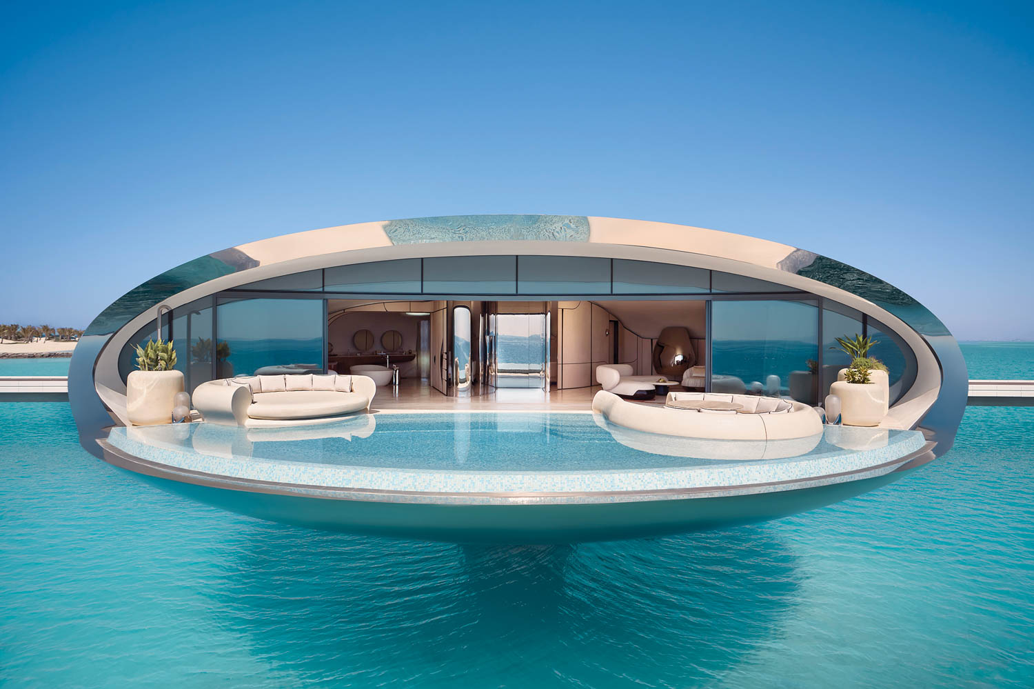 room with large infinity pool and couches overlooking the ocean