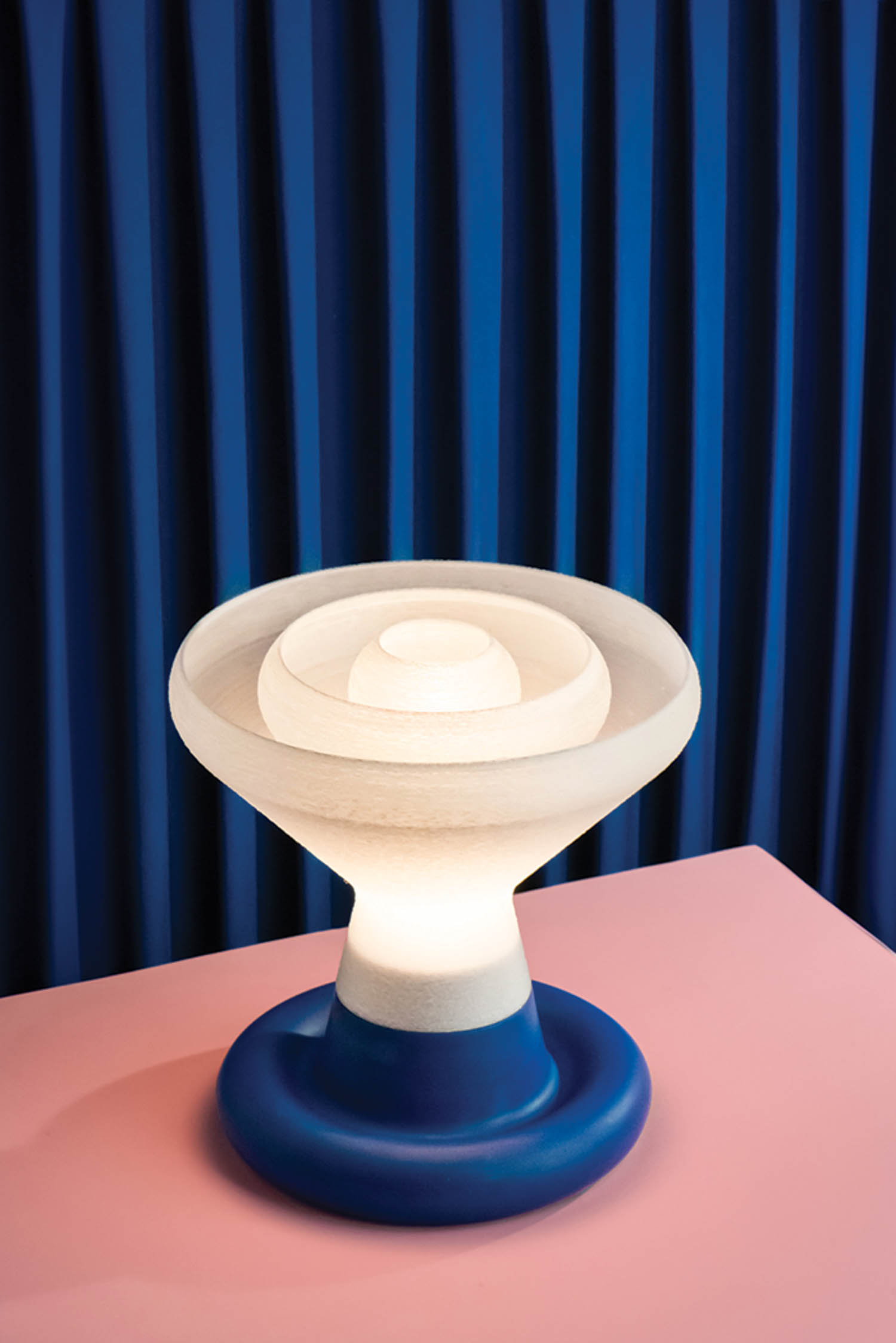 A blue table with a white lamp on top