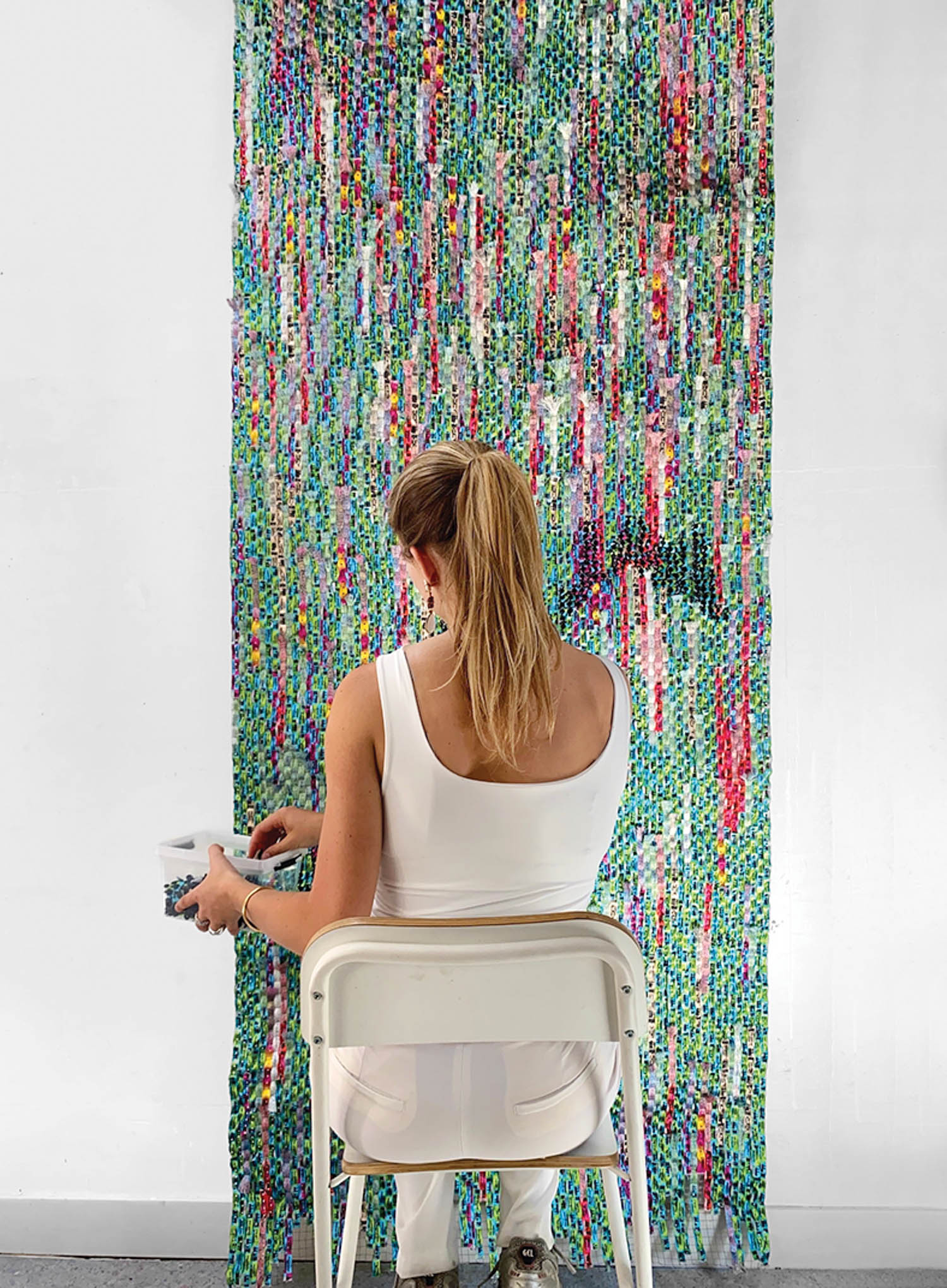 A woman sitting on a chair in front of a wall