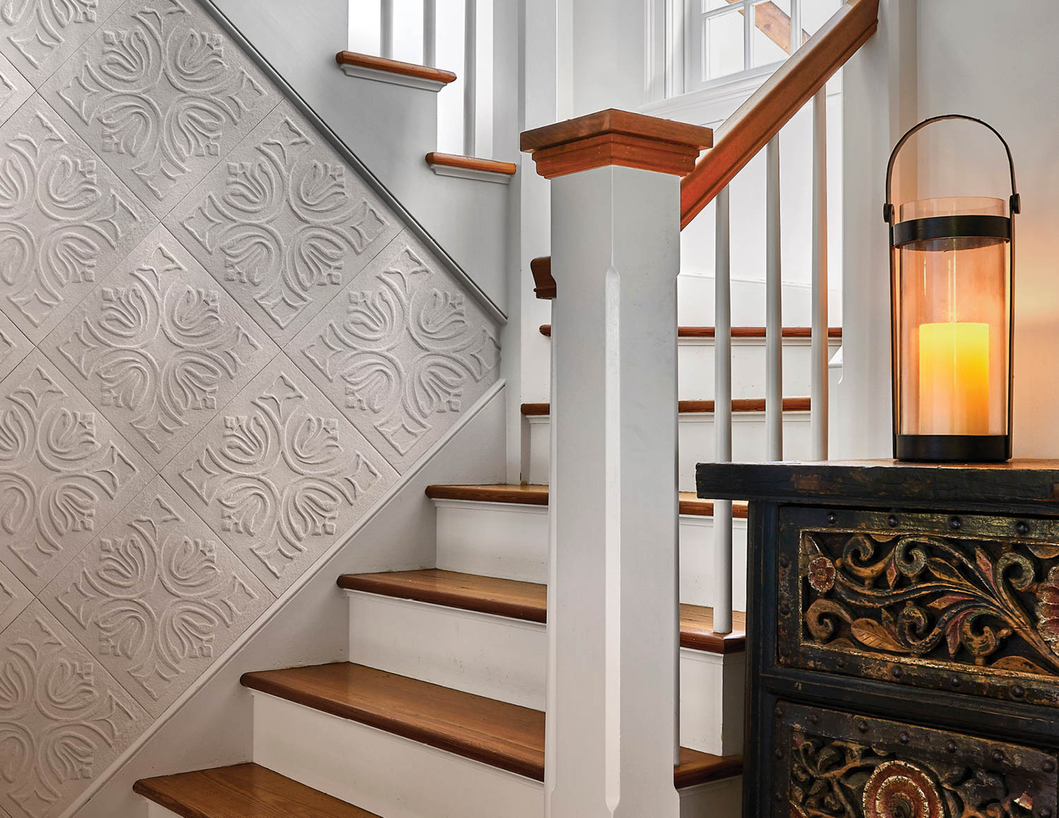 staircase with patterned tiles on the side