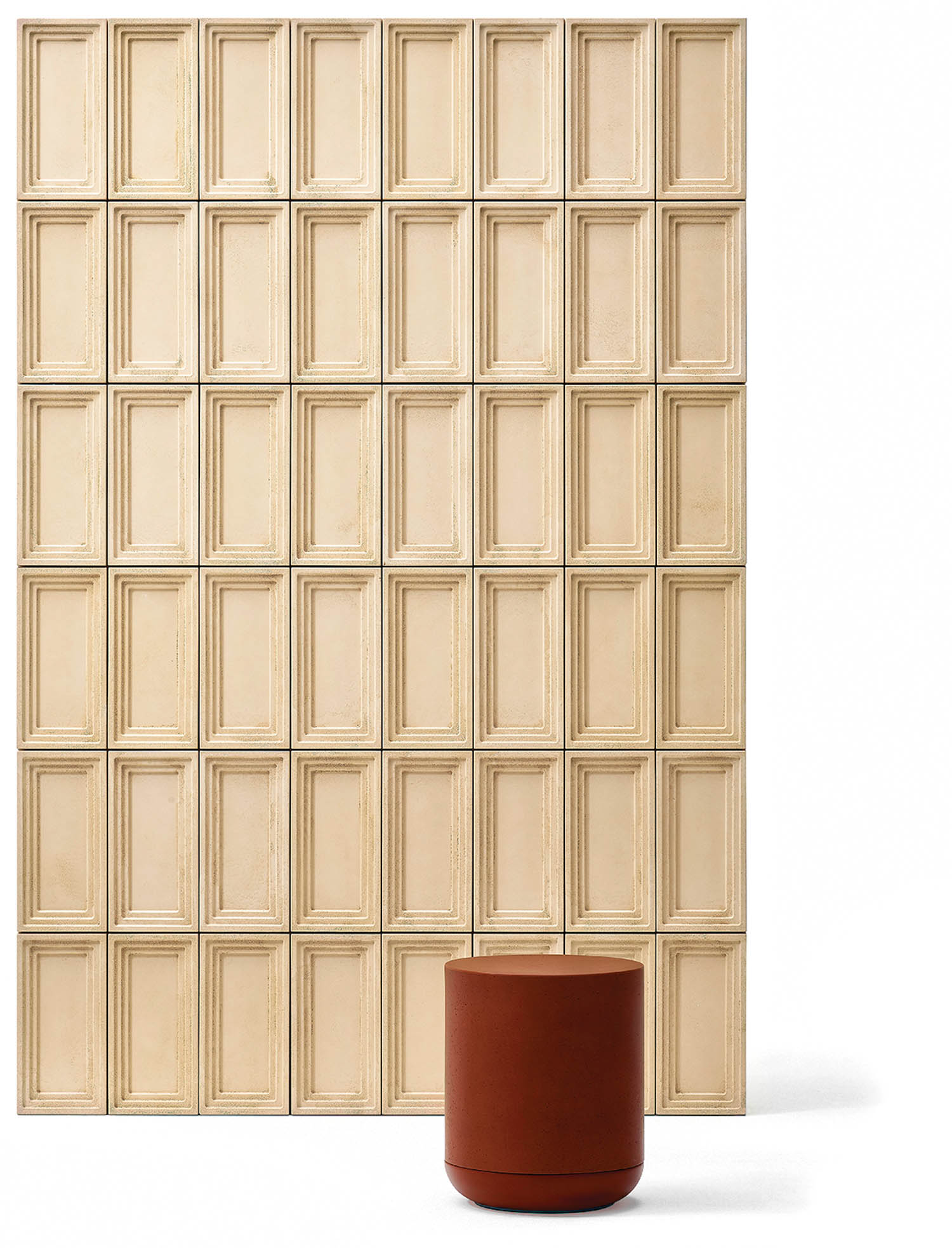 red stool in front of a wall with rectangular tiles