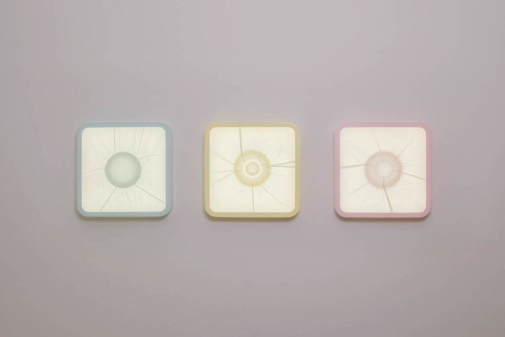 multiple square light sculptures on a wall