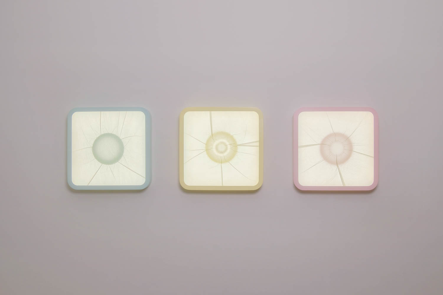 multiple square light sculptures on a wall