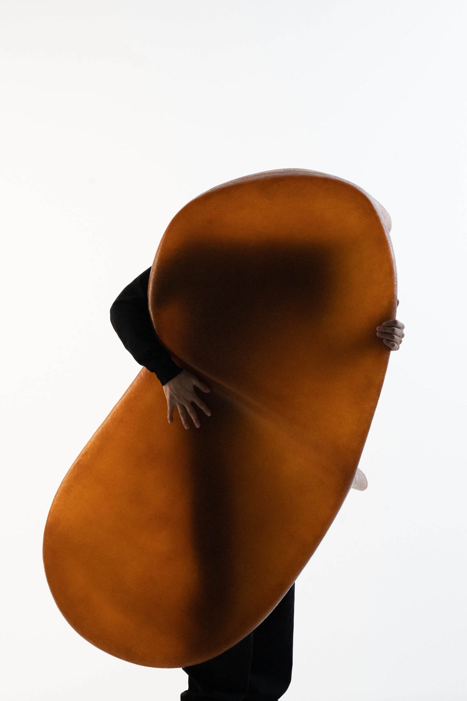 person holding a ovular bronze table