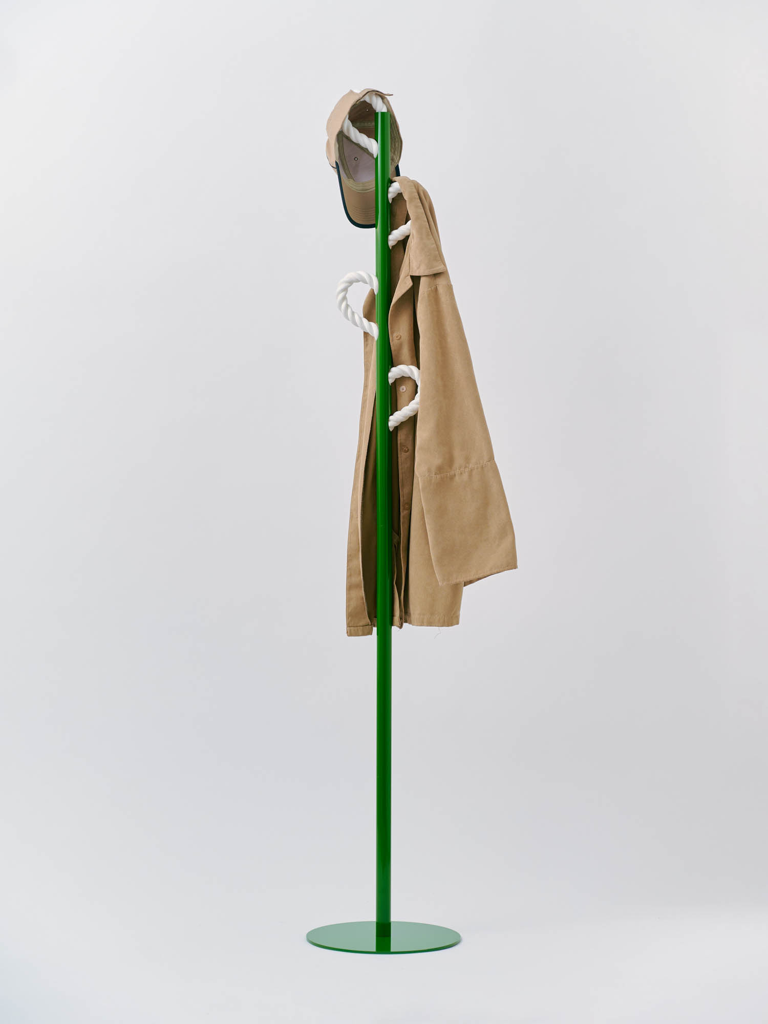 lime green coat rack with tan jacket