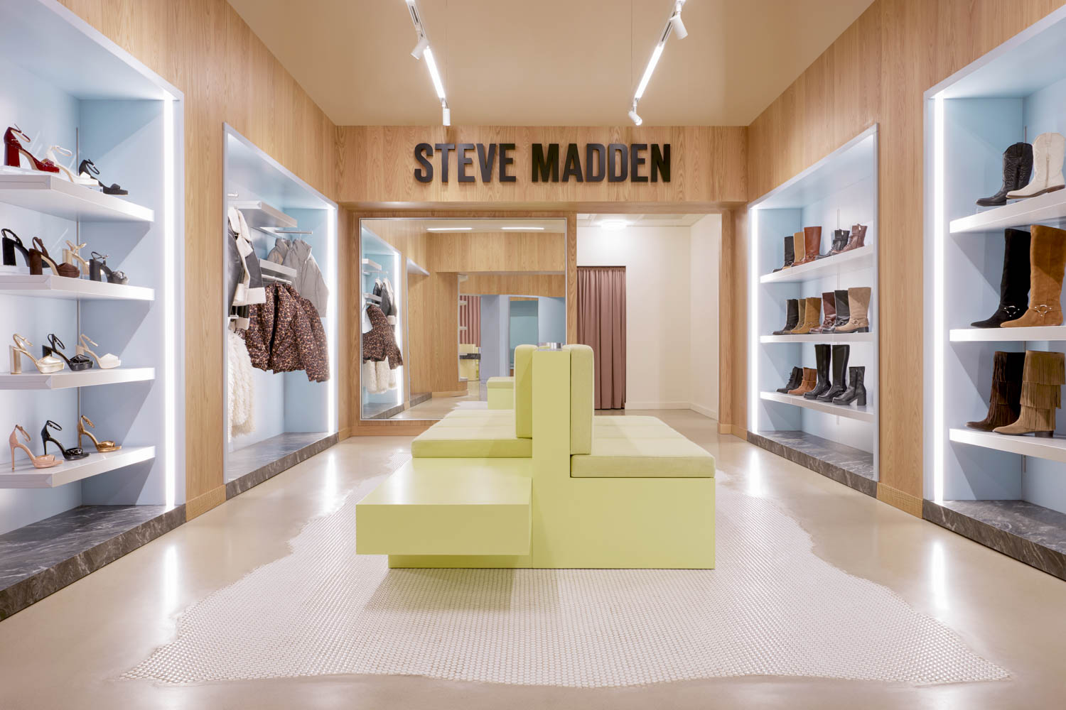 room with multiple shelves and pastel yellow seating area