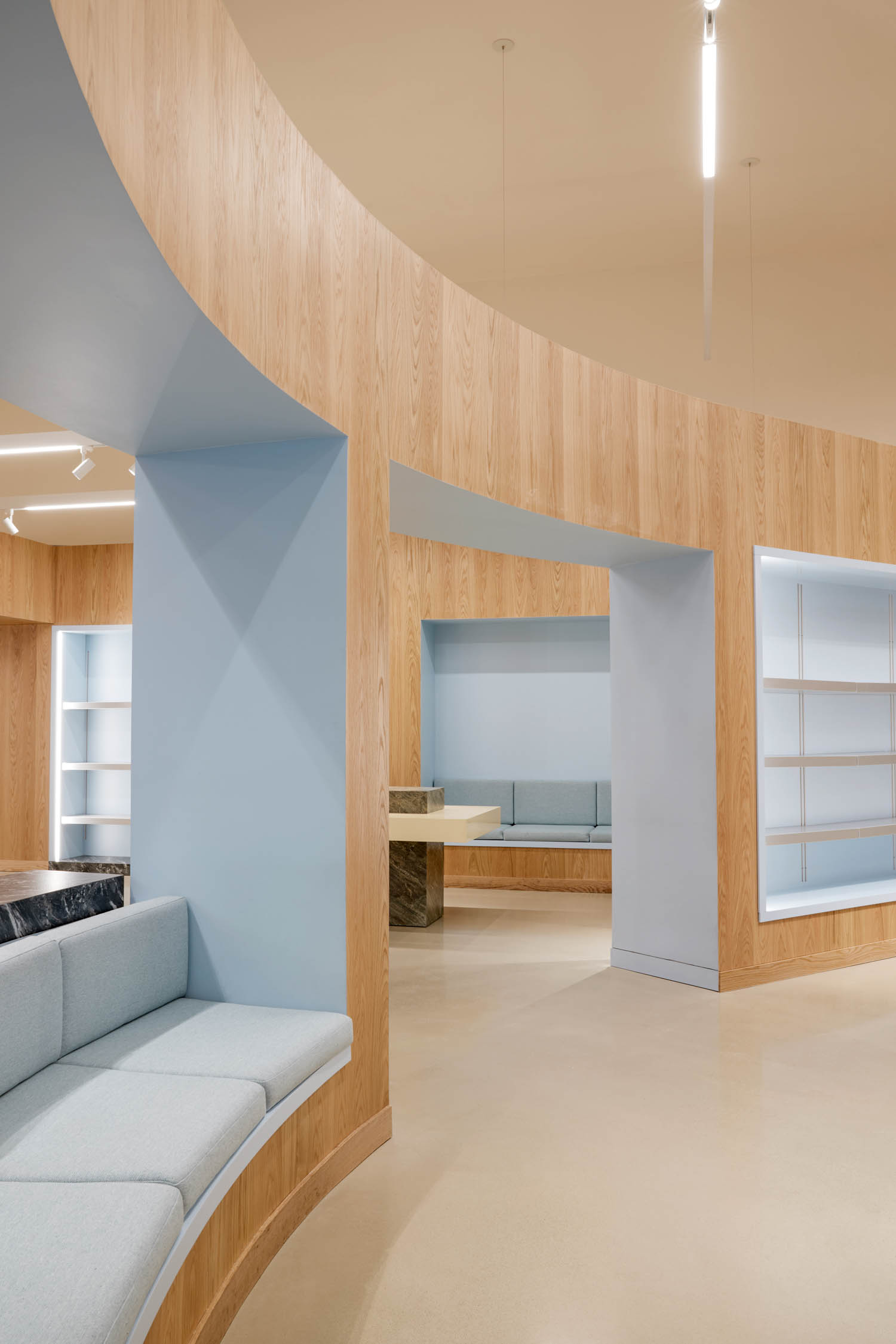 curved area of room with pale blue walls and seats