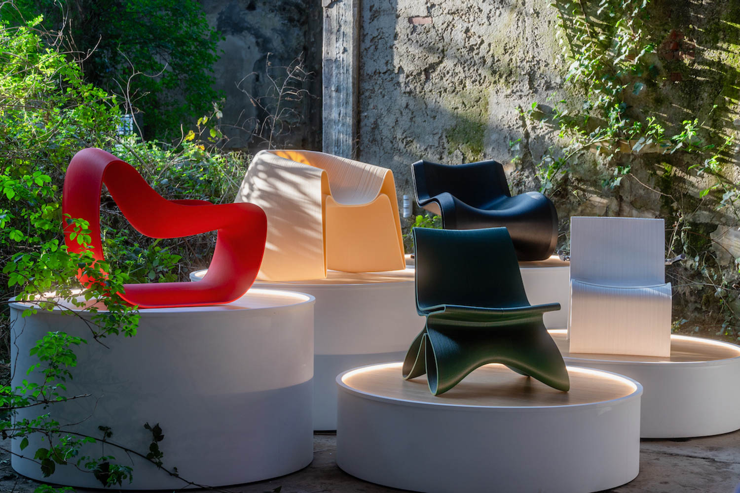 multiple colored chairs on top of stone platforms