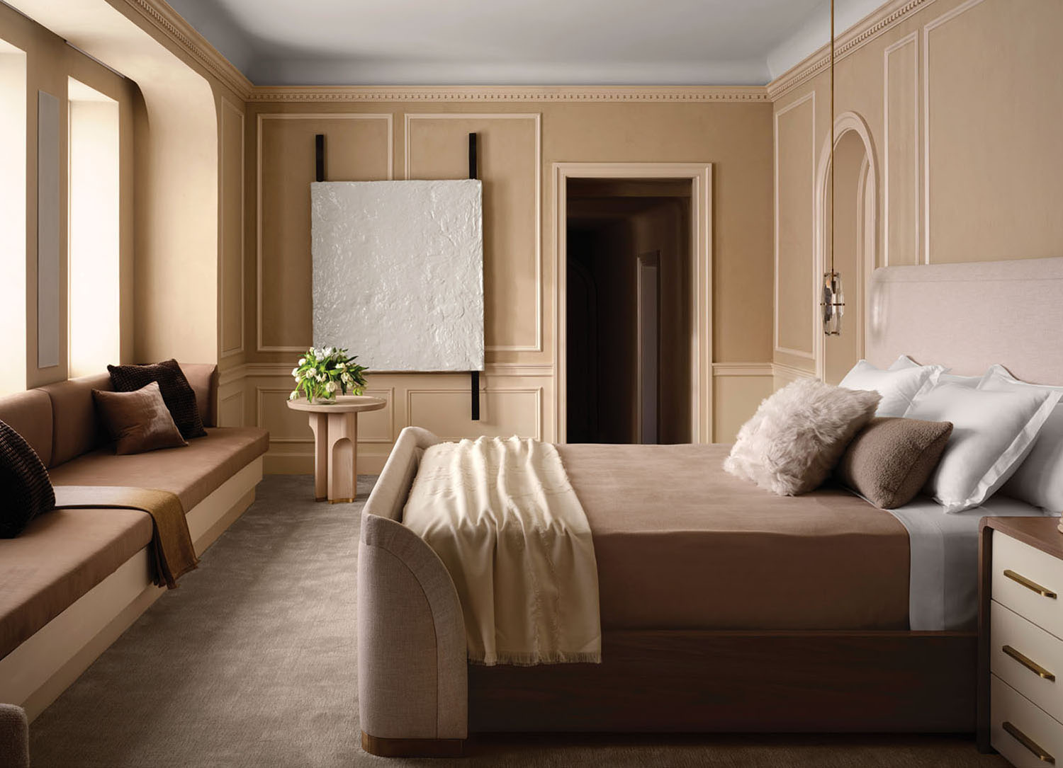 A bedroom with a bed, a couch and a window.