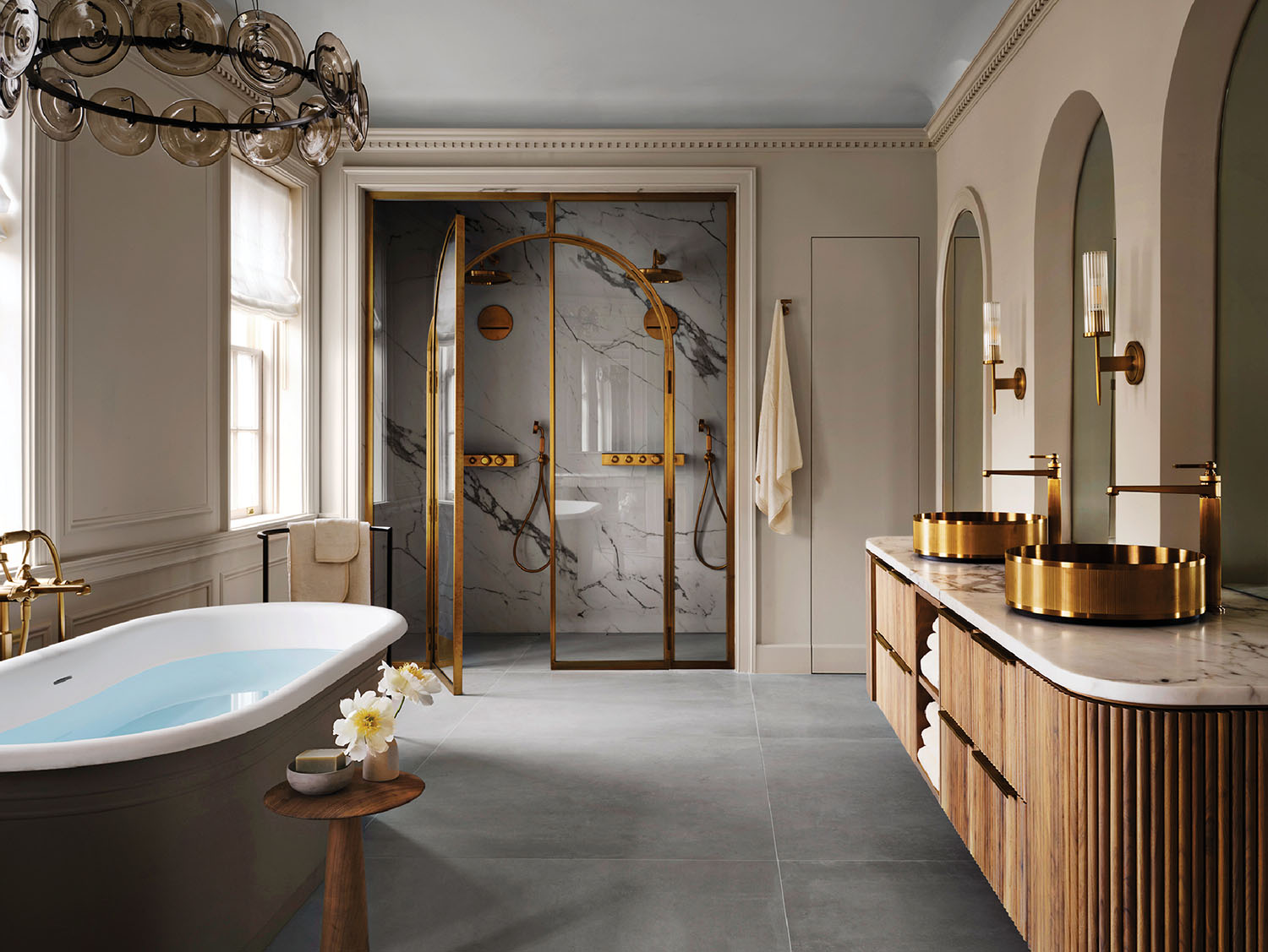 A bathroom with a marble floor and a large tub.