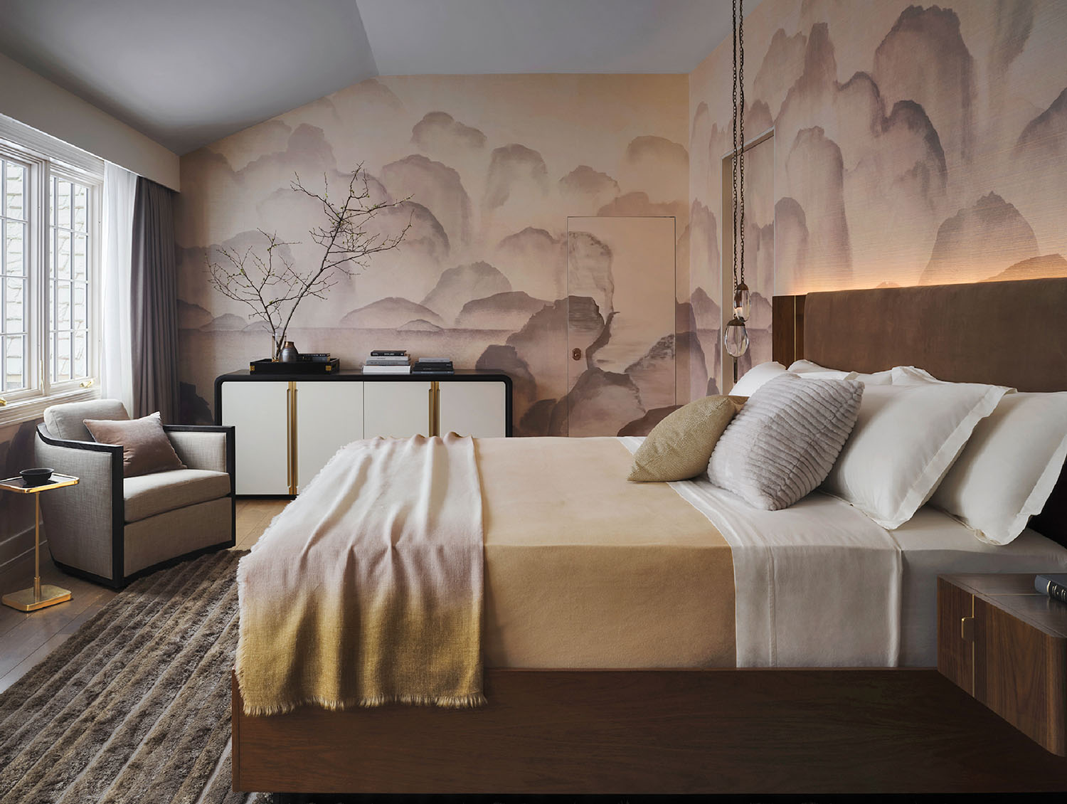 A bedroom with a bed and a painting on the wall.